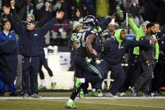 SEATTLE, WA - JANUARY 10:  Kam Chancellor #31 of the Seattle Seahawks runs a 90 yard touchdown off of an interception in the fourth quarter thrown by Cam Newton #1 of the Carolina Panthers during the 2015 NFC Divisional Playoff game at CenturyLink Field o