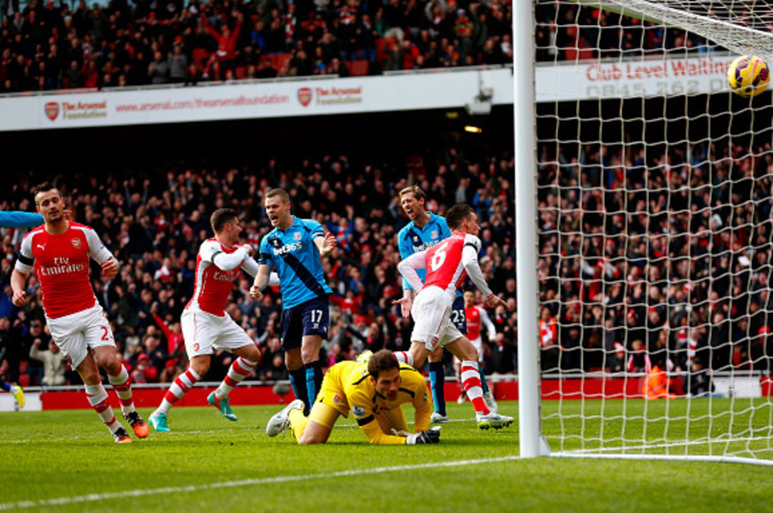 LONDON, ENGLAND - JANUARY 11:  Laurent Koscielny of Arsenal runs away to celebrate after scoring the opening goal past Asmir Begovic of Stoke City during the Barclays Premier League match between Arsenal and Stoke City at Emirates Stadium on January 11, 2