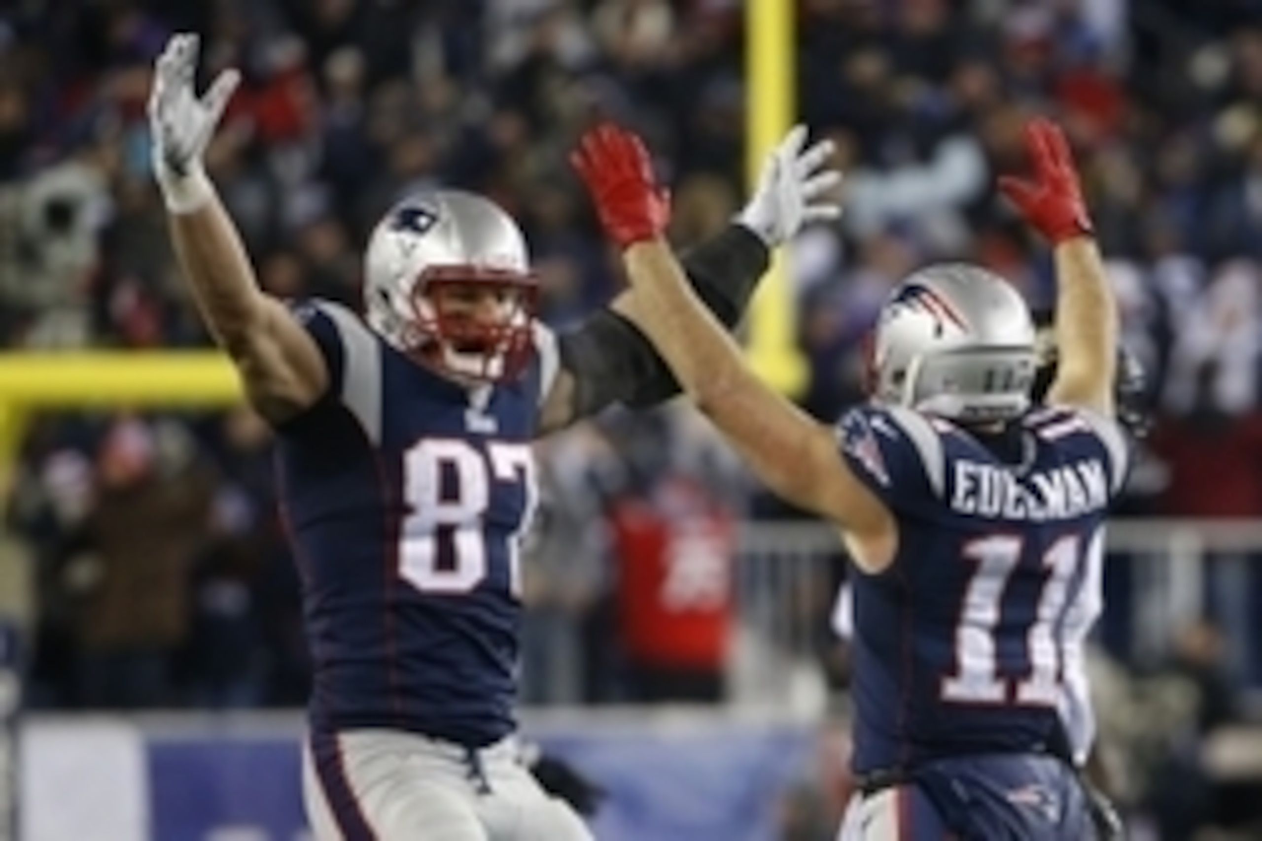 Jan 10, 2015; Foxborough, MA, USA; New England Patriots wide receiver Julian Edelman (11) celebrates with Patriots tight end Rob Gronkowski (87) after throwing a touchdown pass during the fourth quarter against the Baltimore Ravens in the 2014 AFC Divisio