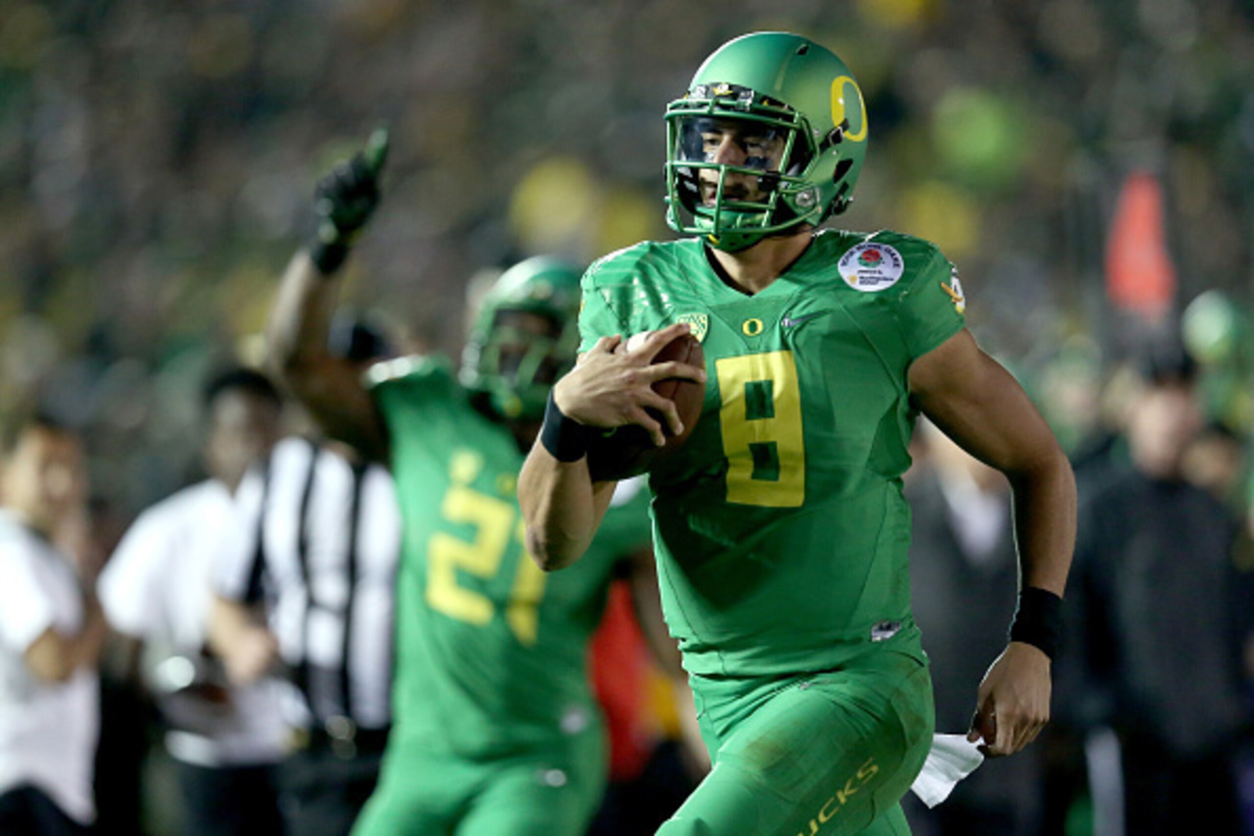 PASADENA, CA - JANUARY 01: Quarterback Marcus Mariota #8 of the Oregon Ducks runs for a 23-yard touchdown in the fourth quarter of the College Football Playoff Semifinal at the Rose Bowl Game presented by Northwestern Mutual at the Rose Bowl on January 1 PASADENA, CA - JANUARY 01: Quarterback Marcus Mariota #8 of the Oregon Ducks runs for a 23-yard touchdown in the fourth quarter of the College Football Playoff Semifinal at the Rose Bowl Game presented by Northwestern Mutual at the Rose Bowl on January 1