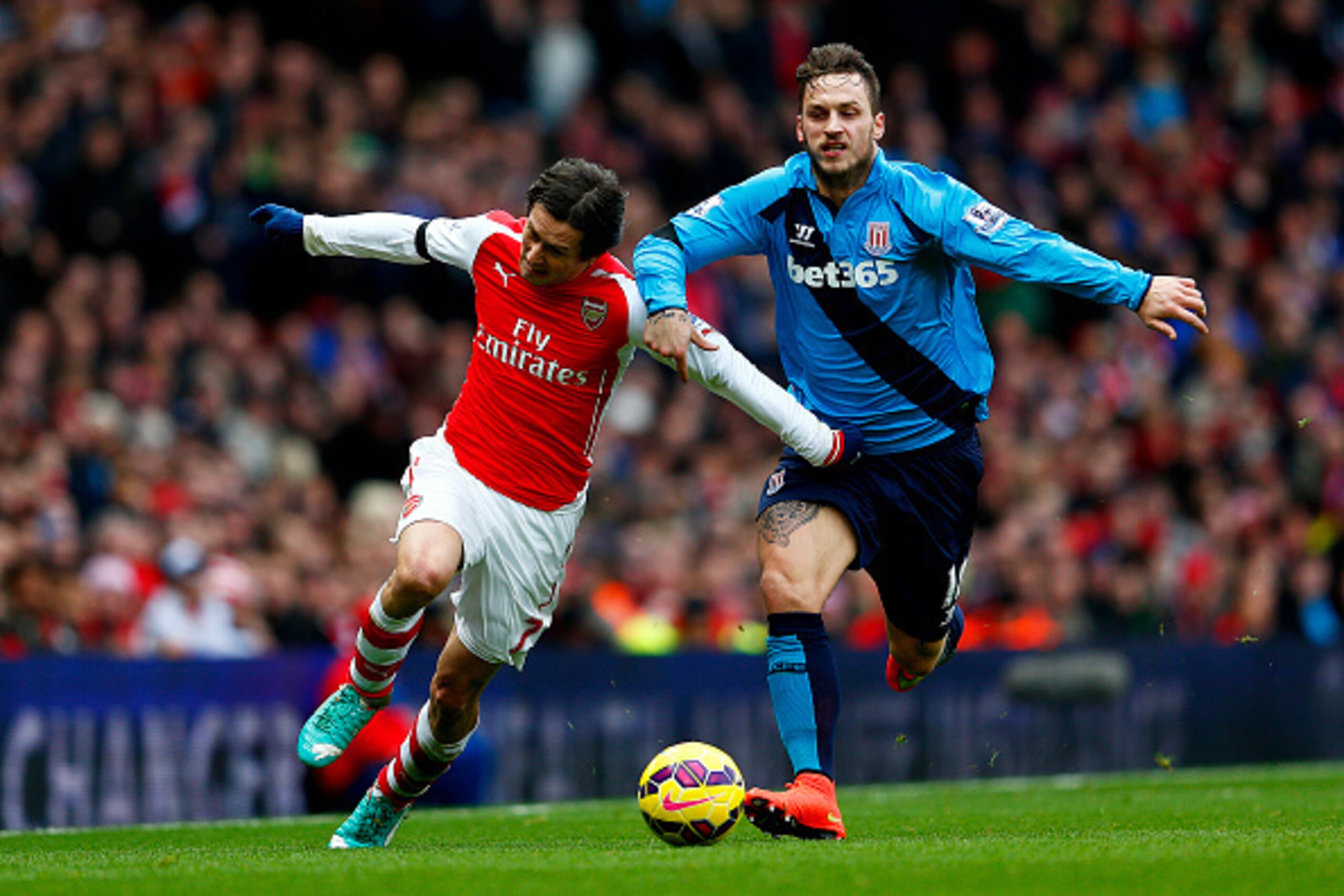 LONDON, ENGLAND - JANUARY 11: Tomas Rosicky of Arsenal battles for the ball with Marko Arnautovic of Stoke City during the Barclays Premier League match between Arsenal and Stoke City at Emirates Stadium on January 11, 2015 in London, England. (Photo by LONDON, ENGLAND - JANUARY 11: Tomas Rosicky of Arsenal battles for the ball with Marko Arnautovic of Stoke City during the Barclays Premier League match between Arsenal and Stoke City at Emirates Stadium on January 11, 2015 in London, England. (Photo by