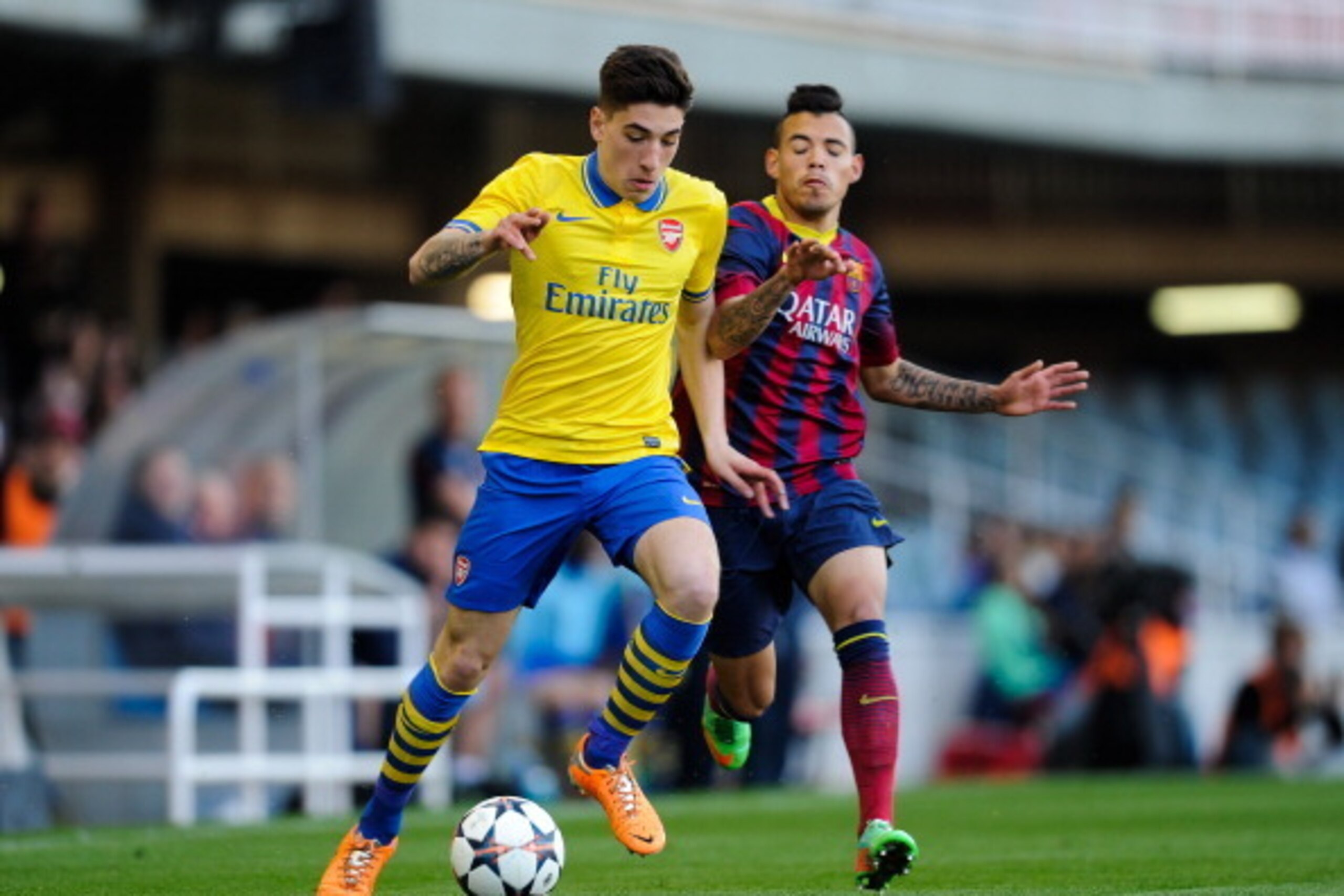 BARCELONA, SPAIN - MARCH 18:  Hector Bellerin of Arsenal duels for the ball with Maxi Rolon of FC Barcelona during the UEFA Youth League Quarter FInal match between FC Barcelona U19 and Arsenal U19 at Mini Estadi on March 18, 2014 in Barcelona, Spain.  (P