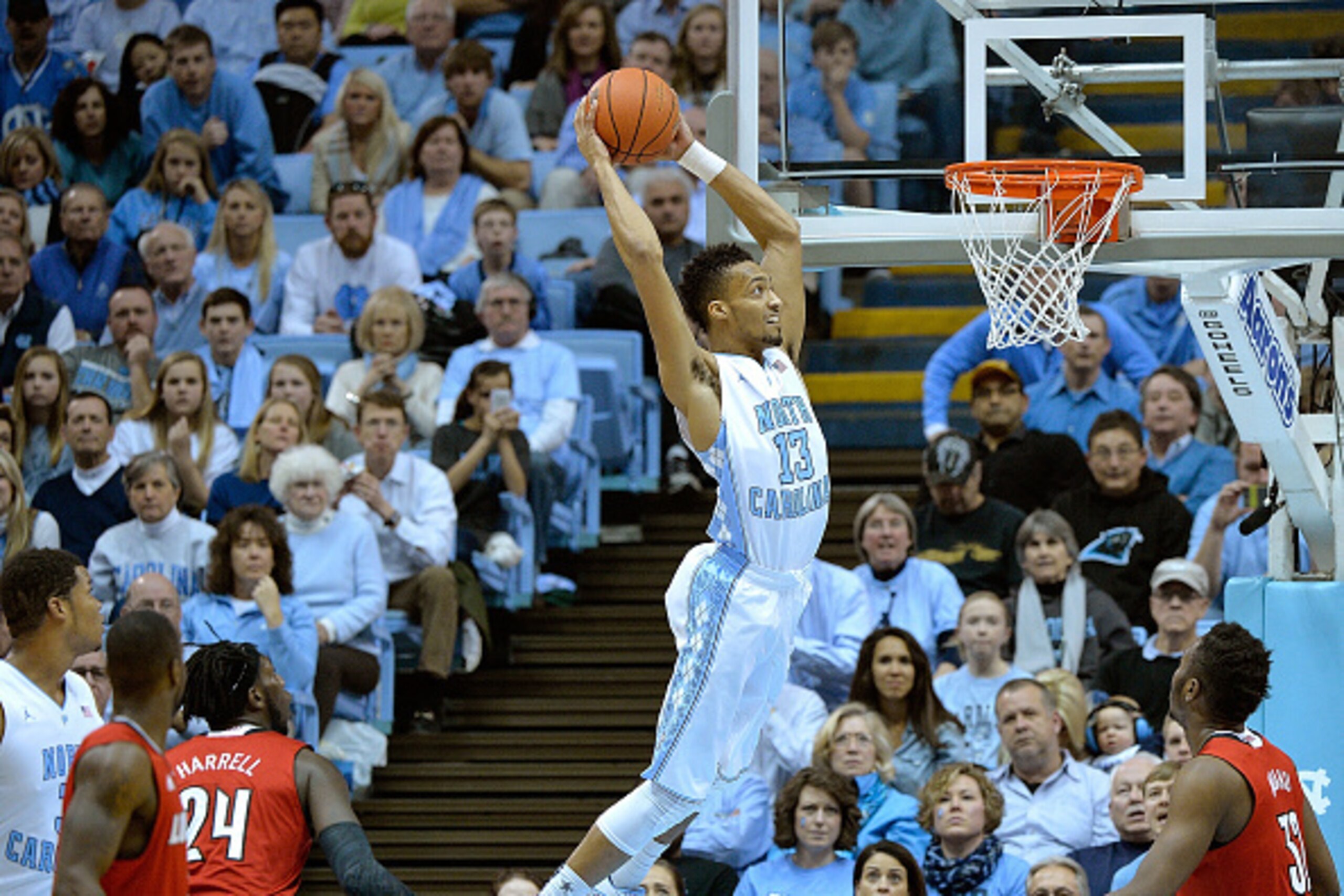 CHAPEL HILL, NC - JANUARY 10:  J.P. Tokoto #13 of the North Carolina Tar Heels drives in for a dunk against the Louisville Cardinals during their game at the Dean Smith Center on January 10, 2015 in Chapel Hill, North Carolina.  (Photo by Grant Halverson/