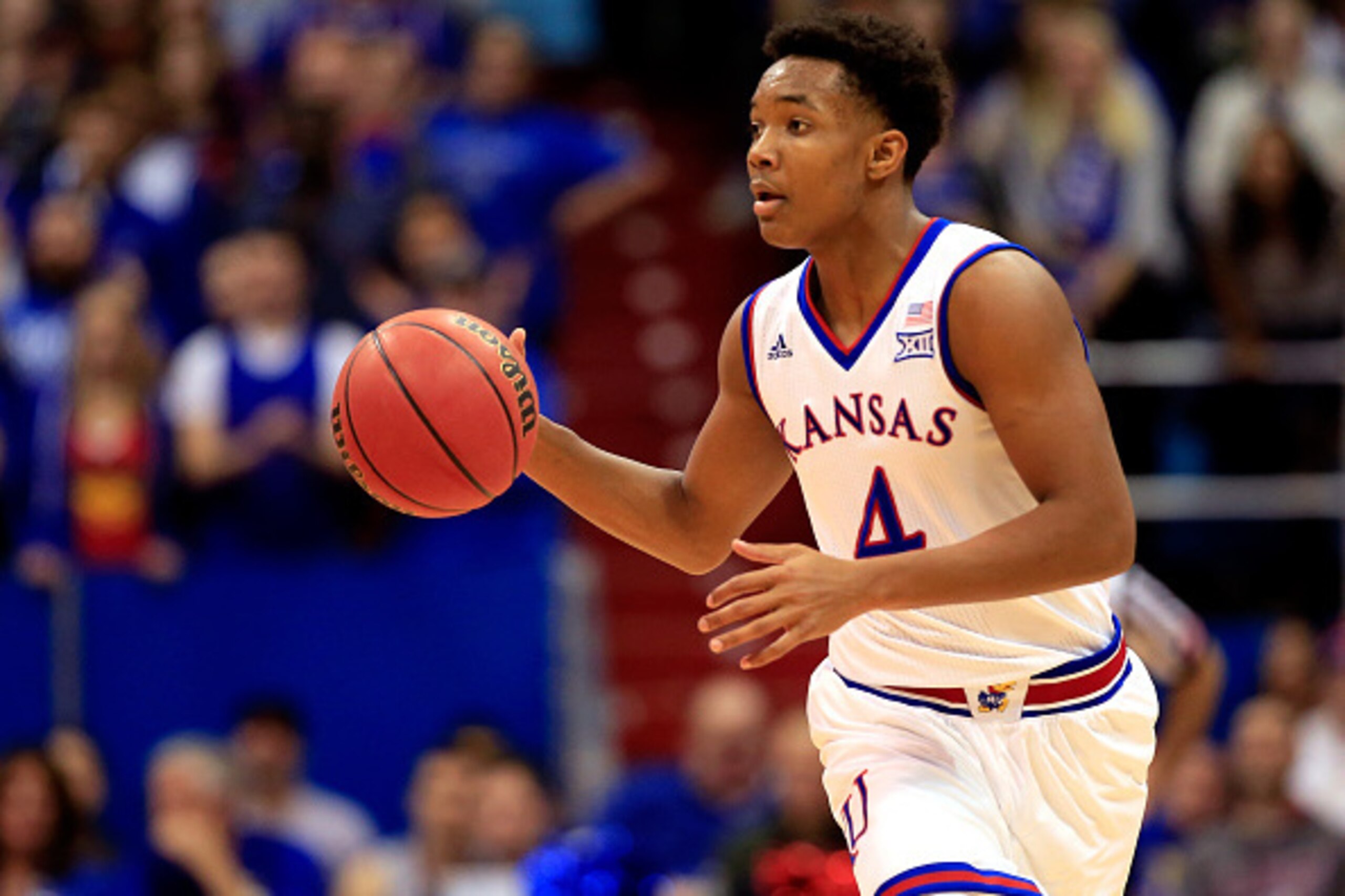 LAWRENCE, KS - JANUARY 10:  Devonte Graham #4 of the Kansas Jayhawks controls the ball during the game against the Texas Tech Red Raiders at Allen Fieldhouse on January 10, 2015 in Lawrence, Kansas.  (Photo by Jamie Squire/Getty Images)