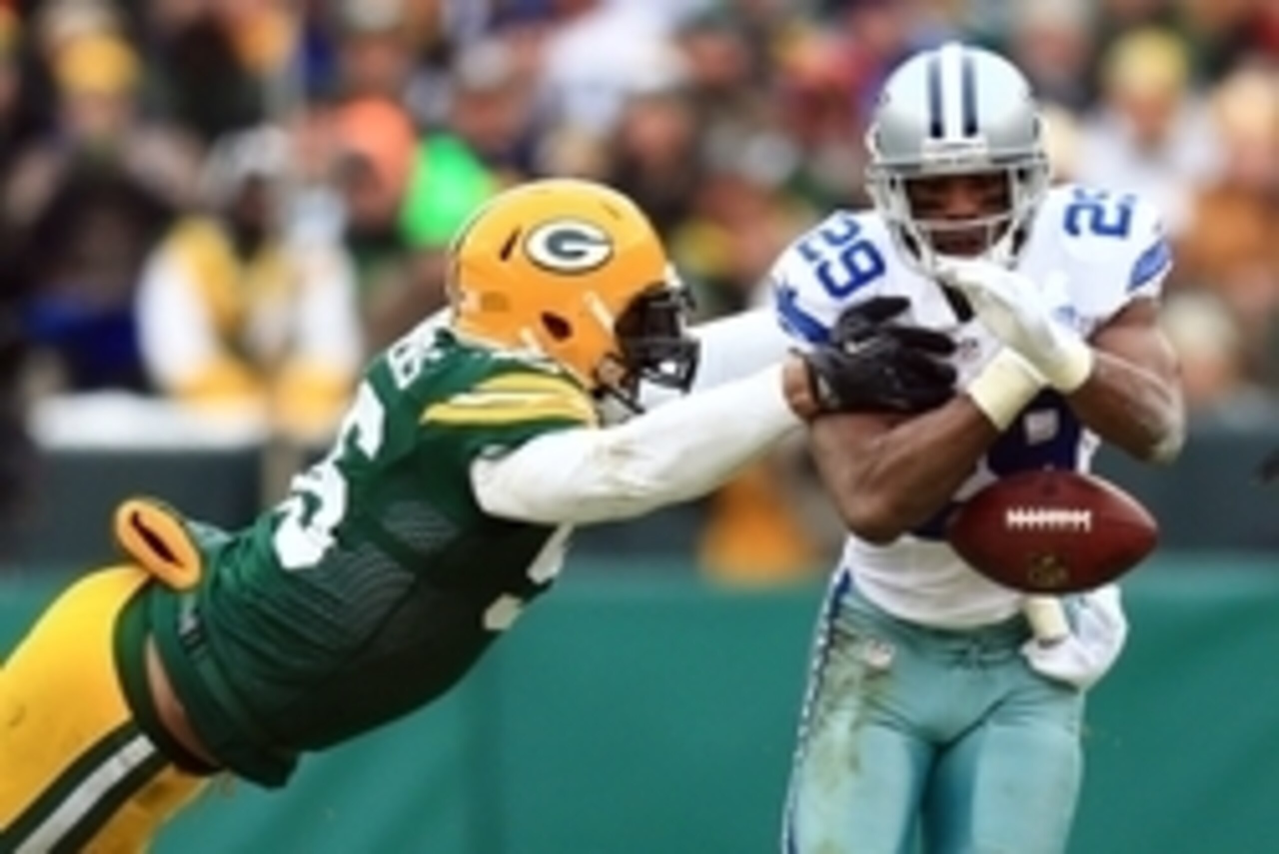 Jan 11, 2015; Green Bay, WI, USA; Dallas Cowboys running back DeMarco Murray (29) fumbles the ball as he is hit by Green Bay Packers outside linebacker Julius Peppers (56) in the third quarter in the second half in the 2014 NFC Divisional playoff football