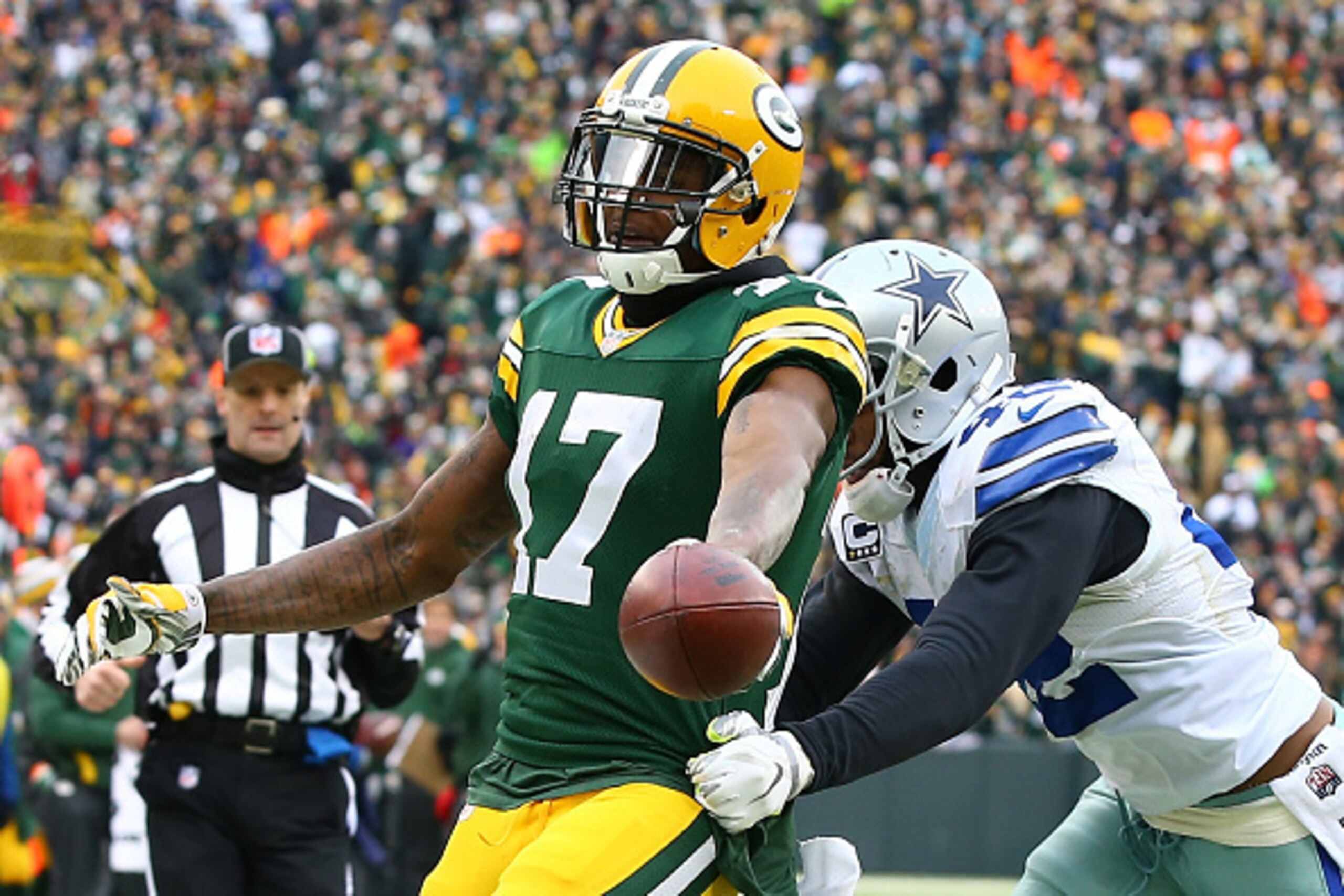 GREEN BAY, WI - JANUARY 11:  Davante Adams #17 of the Green Bay Packers runs into the end-zone past  Barry Church #42 of the Dallas Cowboys for a touchdown in the third quarter of the 2015 NFC Divisional Playoff game at Lambeau Field on January 11, 2015 i