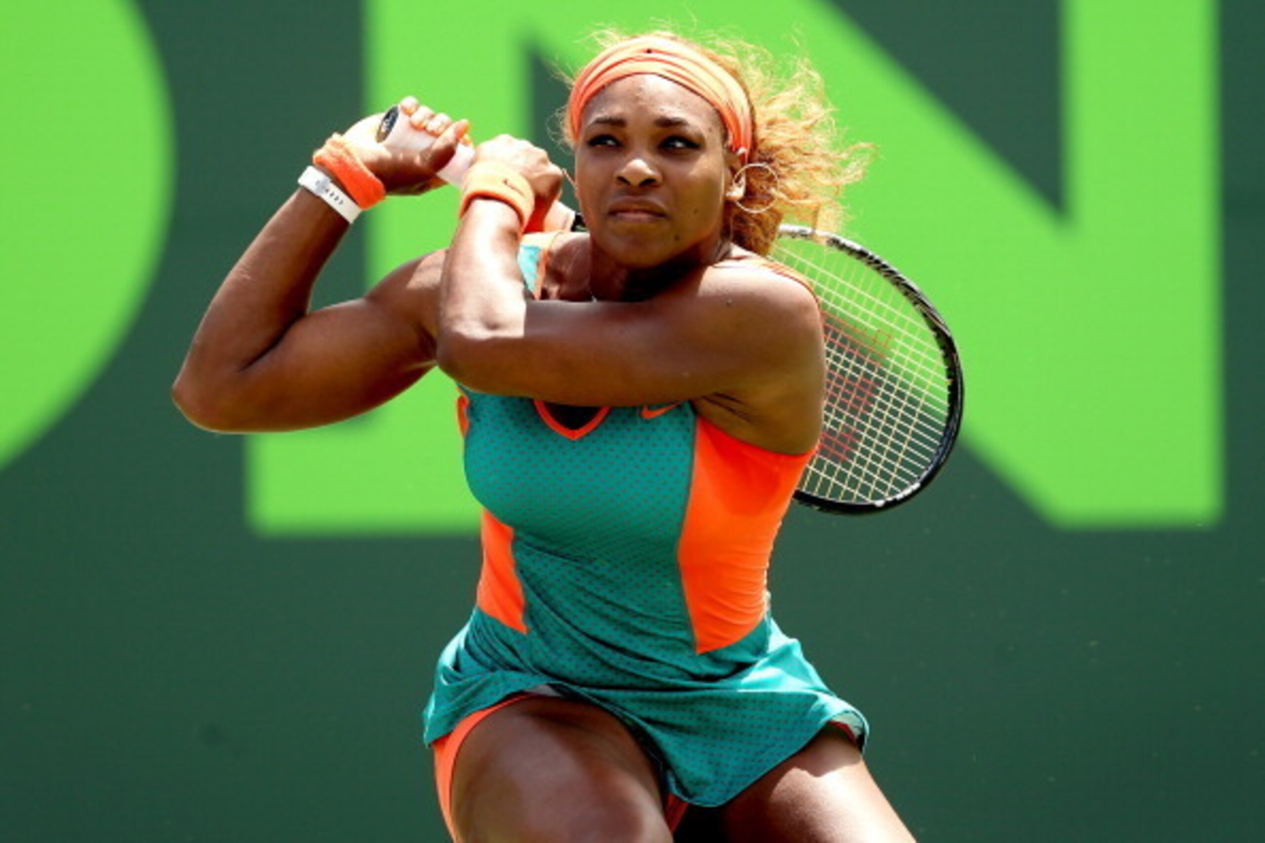 KEY BISCAYNE, FL - MARCH 27:  Serena Williams returns a shot to Maria Sharapova of Russia during the Sony Open at the Crandon Park Tennis Center on March 27, 2014 in Key Biscayne, Florida.  (Photo by Matthew Stockman/Getty Images)