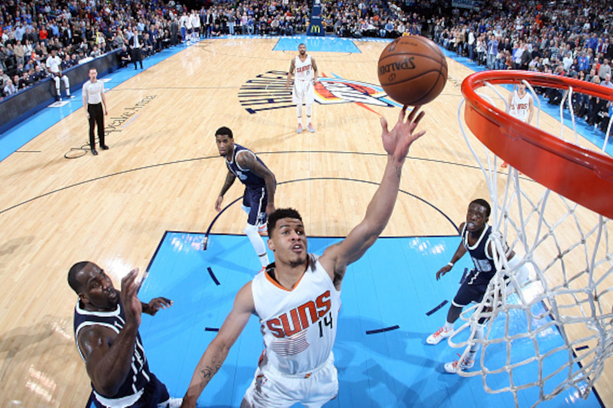 OKLAHOMA CITY, OK - DECEMBER 31: Gerald Green #14 of the Phoenix Suns goes up for a shot against Kendrick Perkins #5 of the Oklahoma City Thunder during an NBA game on December 231, 2014 at the Chesapeake Energy Arena in Oklahoma City, Oklahoma. NOTE TO U