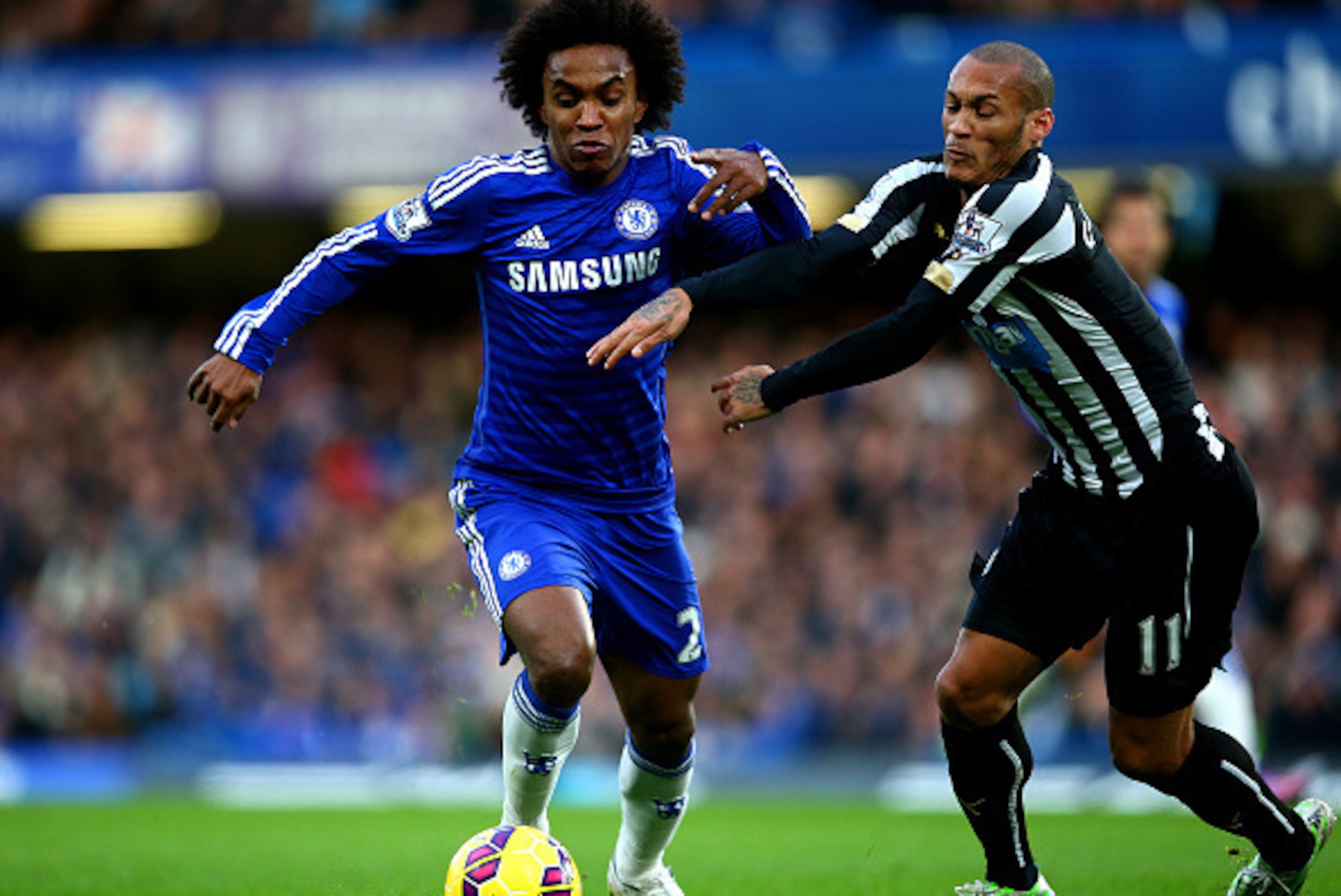 LONDON, ENGLAND - JANUARY 10:  Willian of Chelsea battles for the ball with Yoan Gouffran of Newcastle United during the Barclays Premier League match between Chelsea and Newcastle United at Stamford Bridge on January 10, 2015 in London, England.  (Photo 