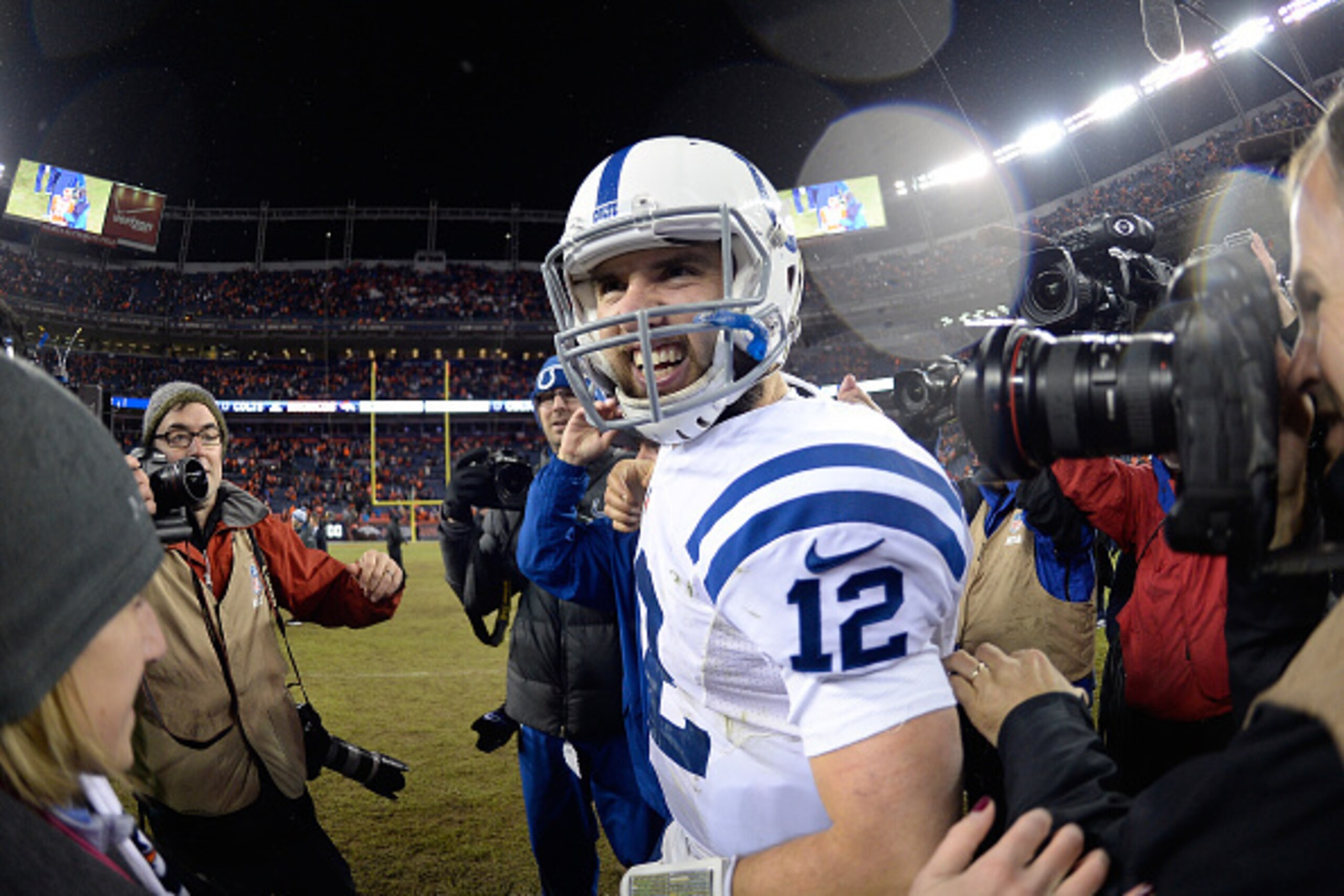 DENVER, CO - JANUARY 11:  Andrew Luck #12 of the Indianapolis Colts smiles as he celebrates the Indianapolis Colts 24-13 win over the Denver Broncos  after a 2015 AFC Divisional Playoff game at Sports Authority Field at Mile High on January 11, 2015 in De
