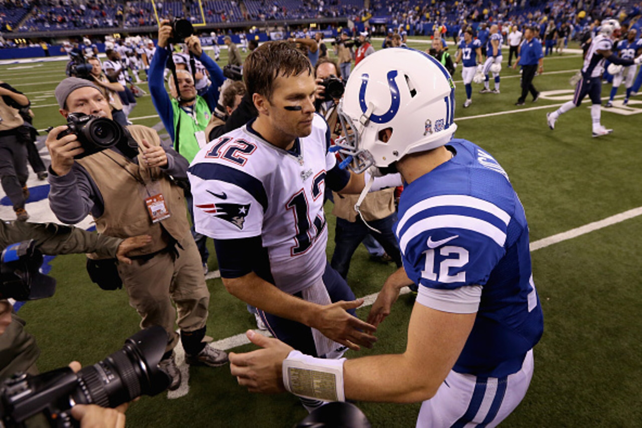 INDIANAPOLIS, IN - NOVEMBER 16: Quarterbacks  Tom Brady #12 of the New England Patriots and  Andrew Luck #12 of the Indianapolis Colts shake hands after the Patriots 42-20 win during the game at Lucas Oil Stadium on November 16, 2014 in Indianapolis, Indi