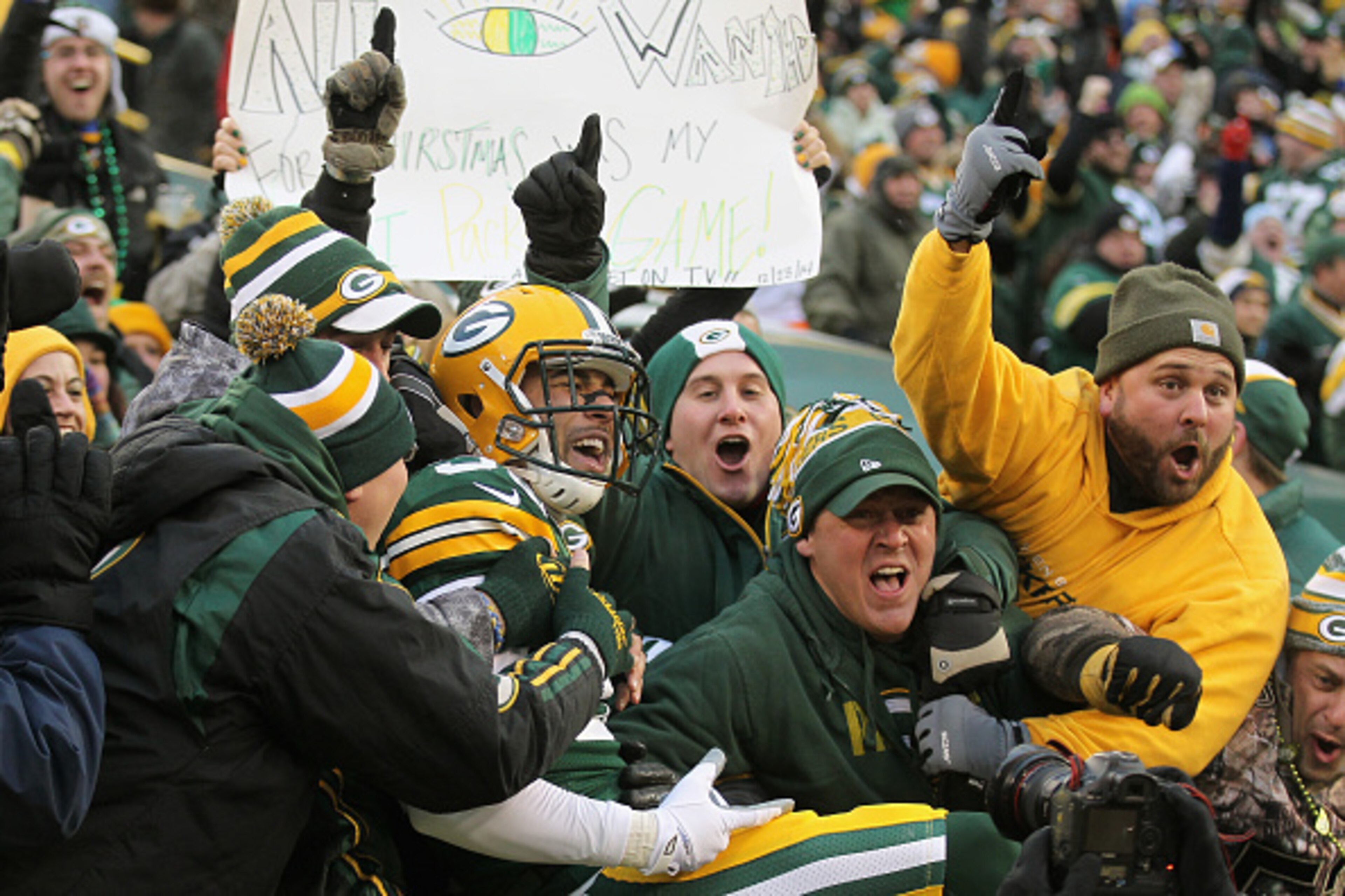 GREEN BAY, WI - DECEMBER 28:  Free safety Micah Hyde #33 of the Green Bay Packers leaps into the crowd after scoring a touchdown on a punt return in the first quarter against the Detroit Lions during the NFL game at Lambeau Field on December 28, 2014 in G
