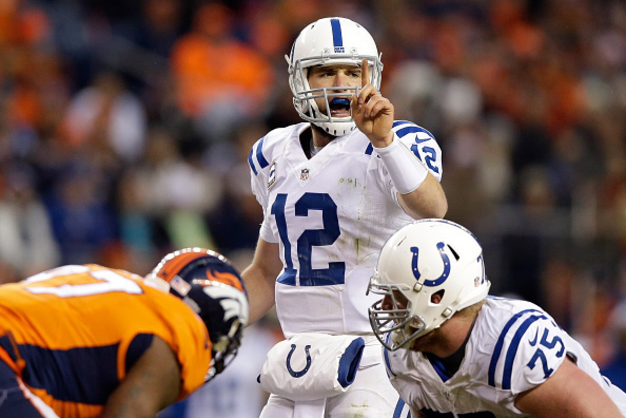 DENVER, CO - JANUARY 11:  Andrew Luck #12 of the Indianapolis Colts runs the offense against the Denver Broncos   during a 2015 AFC Divisional Playoff game at Sports Authority Field at Mile High on January 11, 2015 in Denver, Colorado.  (Photo by Ezra Sha