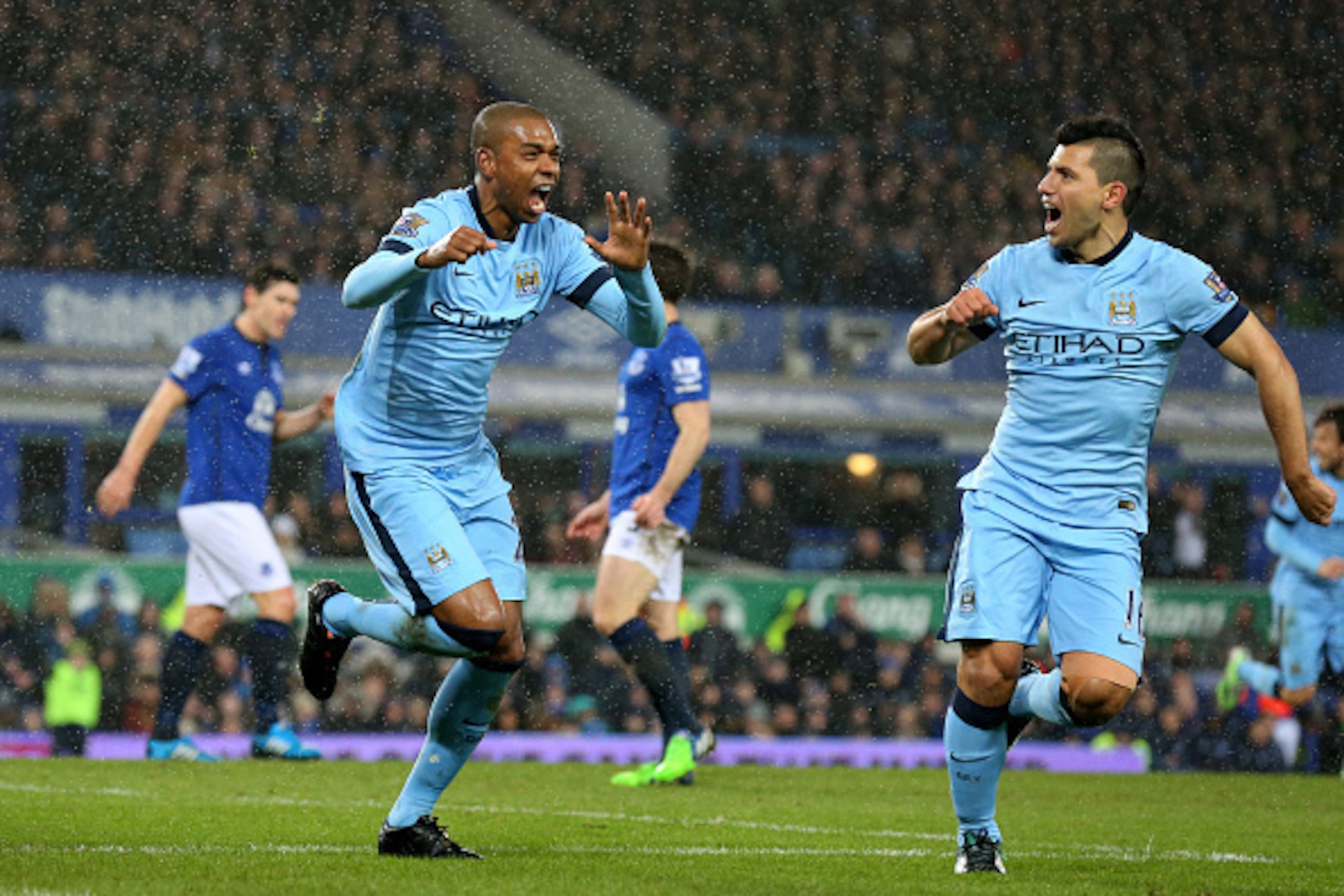 LIVERPOOL, ENGLAND - JANUARY 10:  Fernandinho  of Manchester City celebrates with teammate Sergio Aguero (R) after scoring the opening goal during the Barclays Premier League match between Everton and Manchester City at Goodison Park on January 10, 2015 i