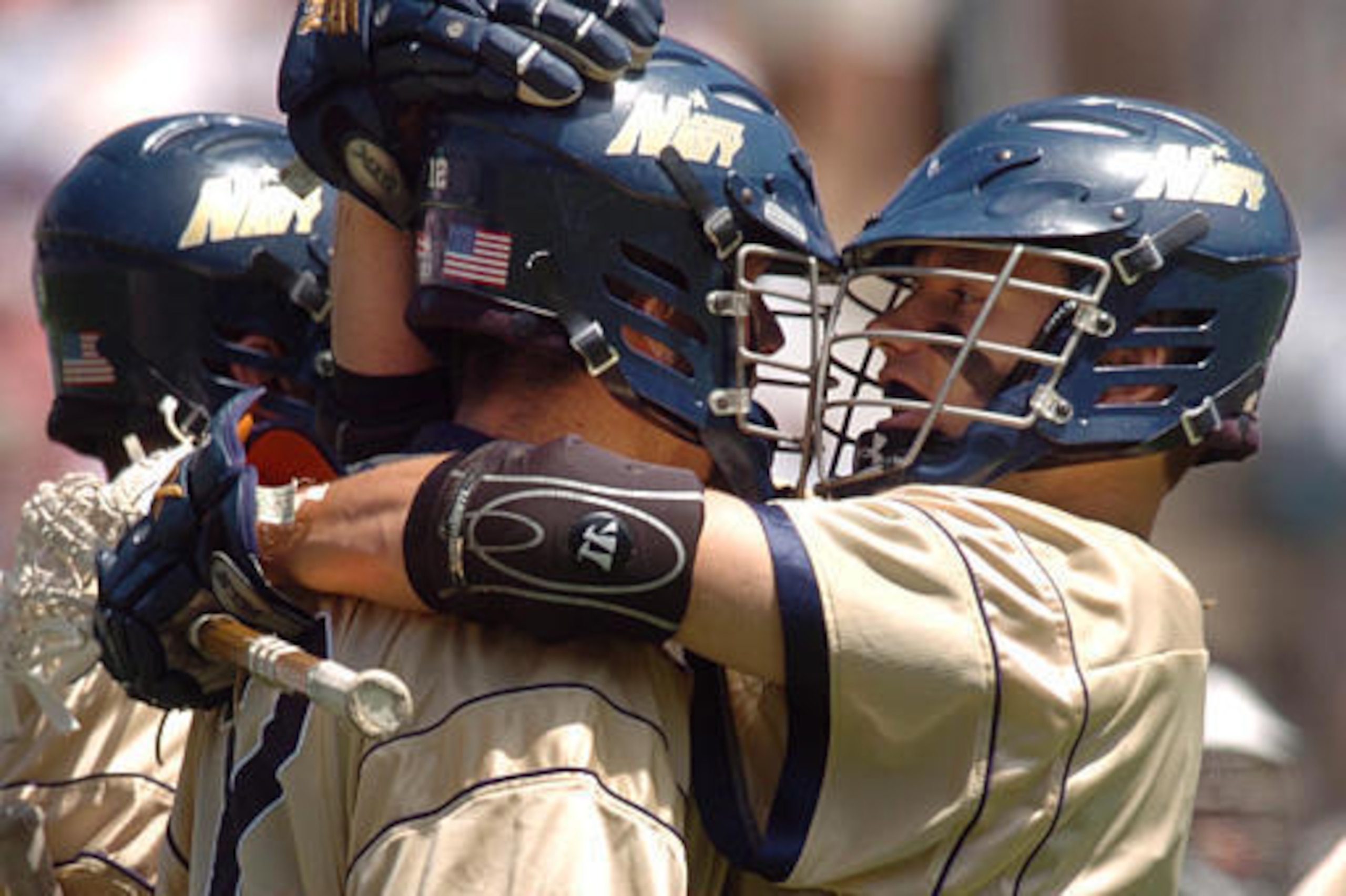 Navy players embrace during a game in 2004.
