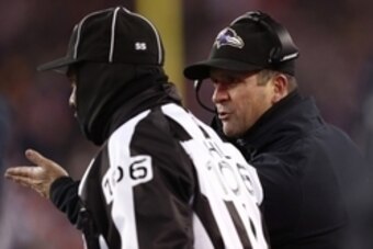Jan 10, 2015; Foxborough, MA, USA; Baltimore Ravens head coach John Harbaugh (R) argues a call with head linesman Wayne Mackie (106) during the second quarter in the 2014 AFC Divisional playoff football game at Gillette Stadium. Mandatory Credit: Mark L. 