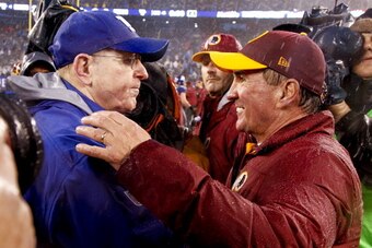 EAST RUTHERFORD, NJ - DECEMBER 29:   Head coach Tom Coughlin of the New York Giants (L) greets head coach Mike Shanahan of the Washington Redskins  after their game at MetLife Stadium on December 29, 2013 in East Rutherford, New Jersey.  (Photo by Jeff Ze