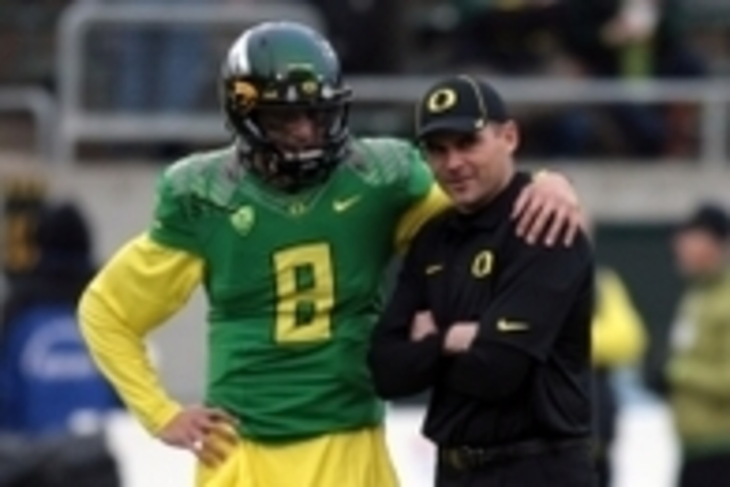 Nov 29, 2013; Eugene, OR, USA; Oregon Ducks head coach Mark Helfrich and quarterback Marcus Mariota (8) talk before the game against the Oregon State Beavers at Matthew Knight Arena. Mandatory Credit: Scott Olmos-USA TODAY Sports