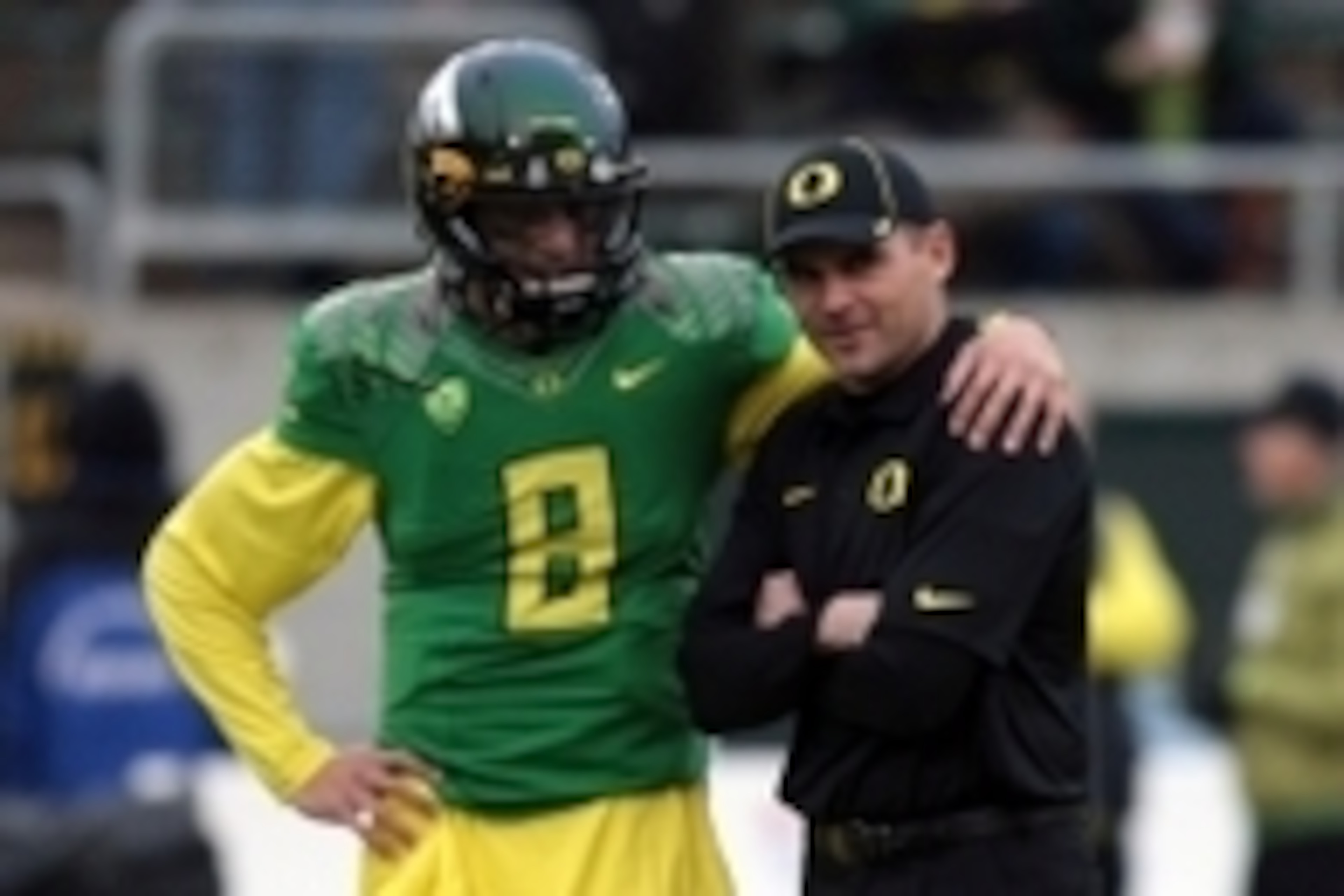 Nov 29, 2013; Eugene, OR, USA; Oregon Ducks head coach Mark Helfrich and quarterback Marcus Mariota (8) talk before the game against the Oregon State Beavers at Matthew Knight Arena. Mandatory Credit: Scott Olmos-USA TODAY Sports