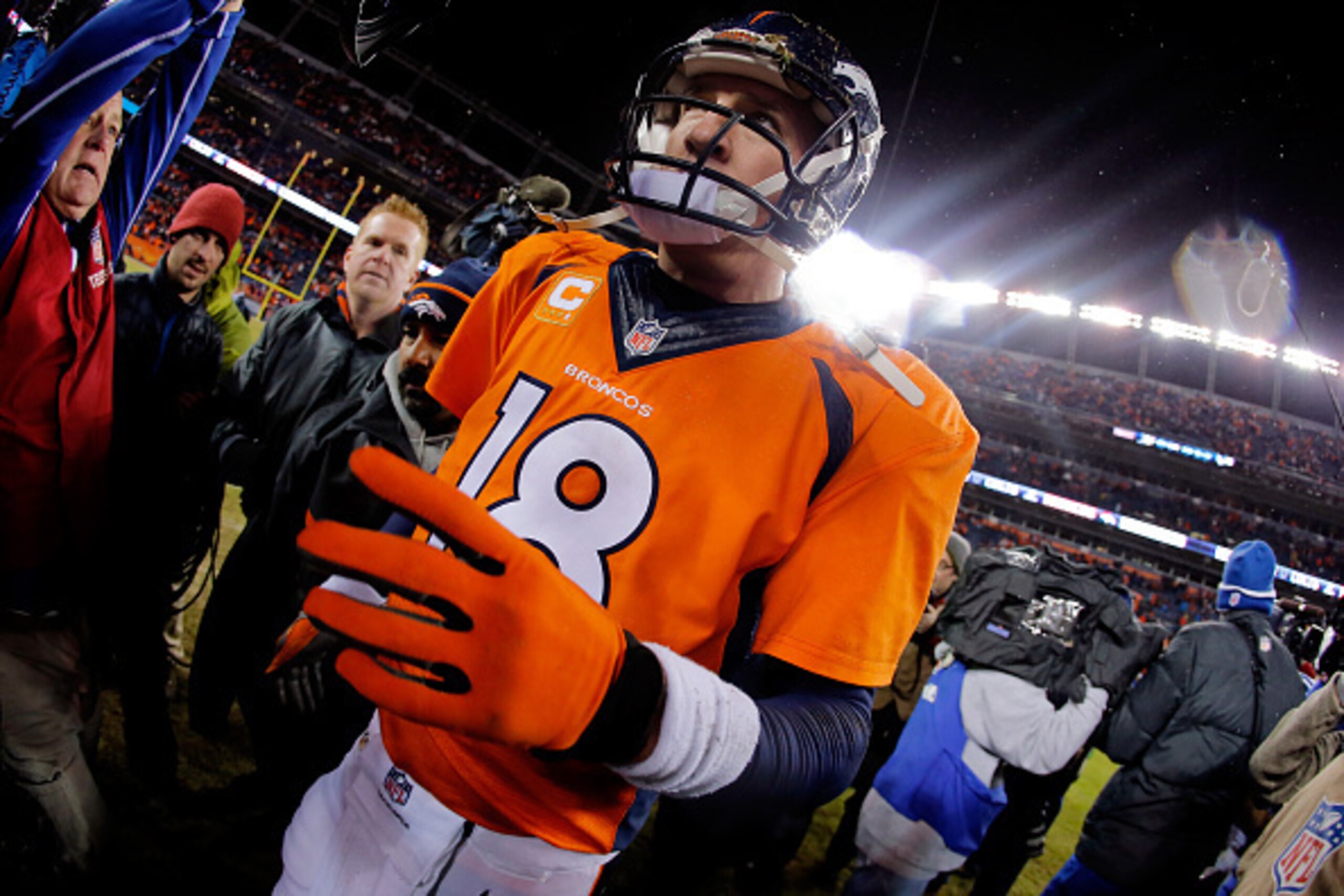DENVER, CO - JANUARY 11:  Peyton Manning #18 of the Denver Broncos walks off the field after losing 24-13 to the Indianapolis Colts in a 2015 AFC Divisional Playoff game at Sports Authority Field at Mile High on January 11, 2015 in Denver, Colorado.  (Pho