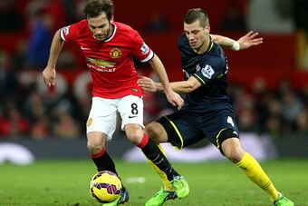 MANCHESTER, ENGLAND - JANUARY 11:  Juan Mata of Manchester United battles for the ball with Morgan Schneiderlin of Southampton during the Barclays Premier League match between Manchester United and Southampton at Old Trafford on January 11, 2015 in Manche