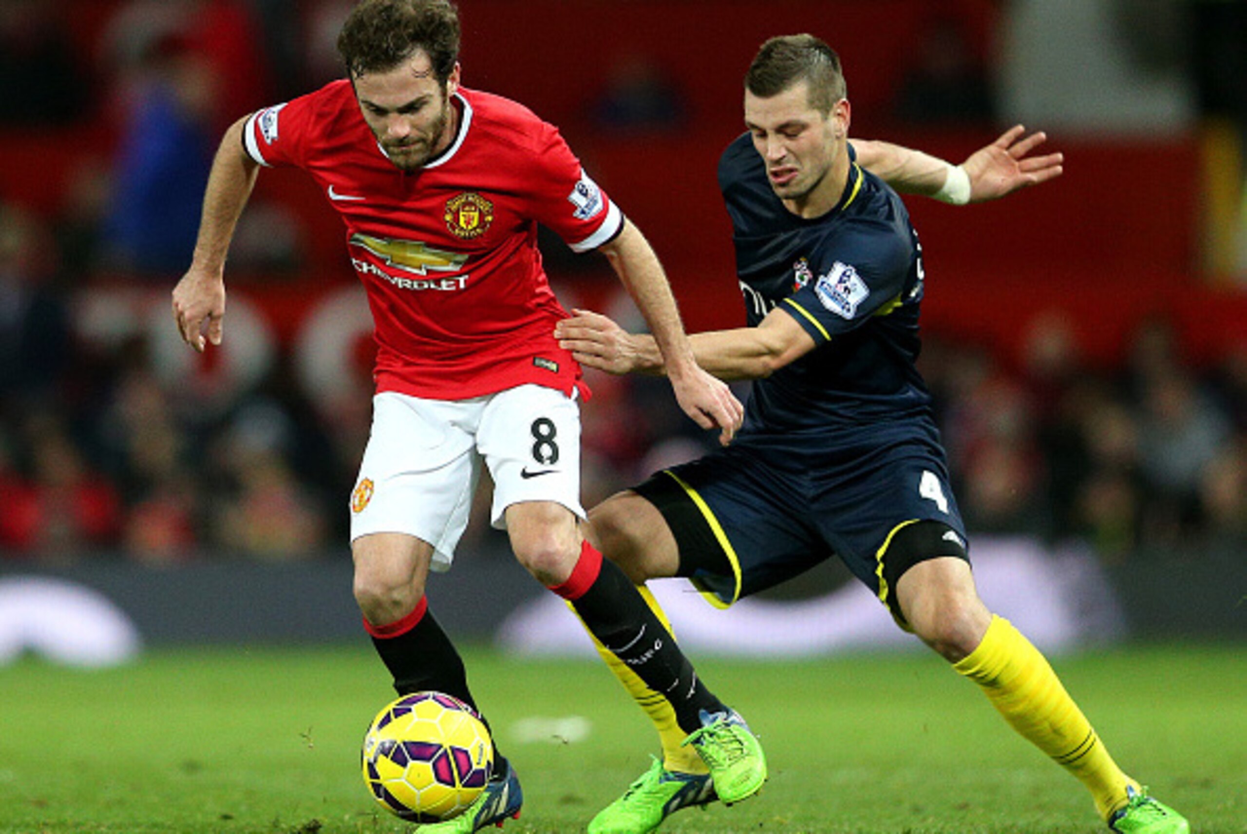 MANCHESTER, ENGLAND - JANUARY 11:  Juan Mata of Manchester United battles for the ball with Morgan Schneiderlin of Southampton during the Barclays Premier League match between Manchester United and Southampton at Old Trafford on January 11, 2015 in Manche