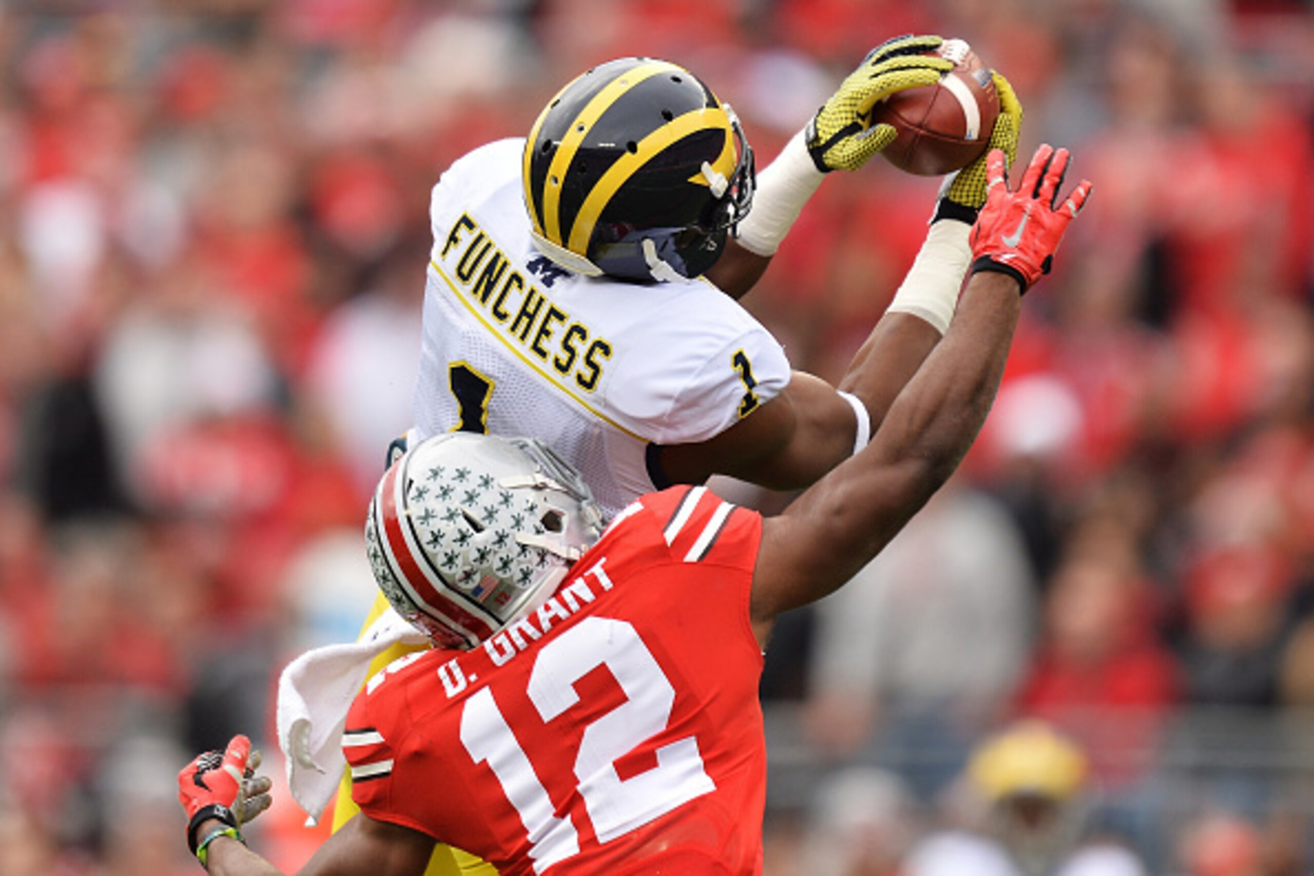 COLUMBUS, OH - NOVEMBER 29:  Devin Funchess #1 of the Michigan Wolverines catches a 45-yard pass in front of Doran Grant #12 of the Ohio State Buckeyes in the first quarter at Ohio Stadium on November 29, 2014 in Columbus, Ohio.  (Photo by Jamie Sabau/Get