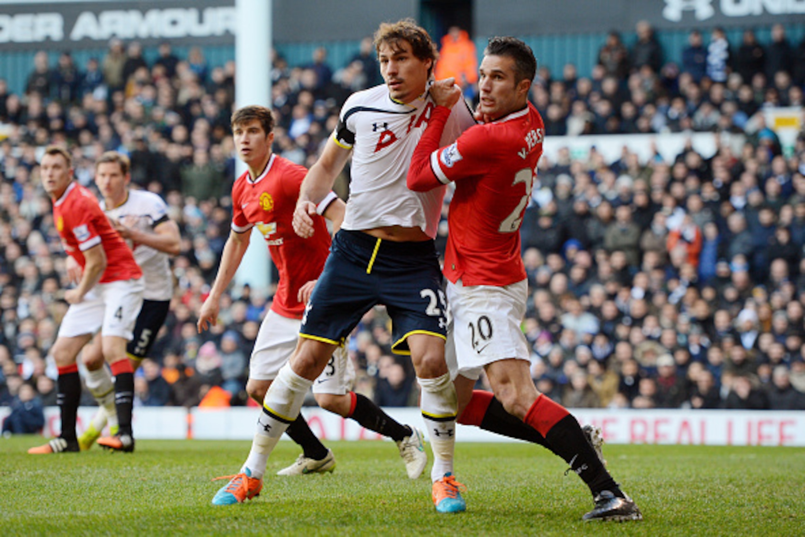 LONDON, ENGLAND - DECEMBER 28:  Benjamin Stambouli of Spurs is manhandled by Robin van Persie of Manchester United during the Barclays Premier League match between Tottenham Hotspur and Manchester United at White Hart Lane on December 28, 2014 in London, 