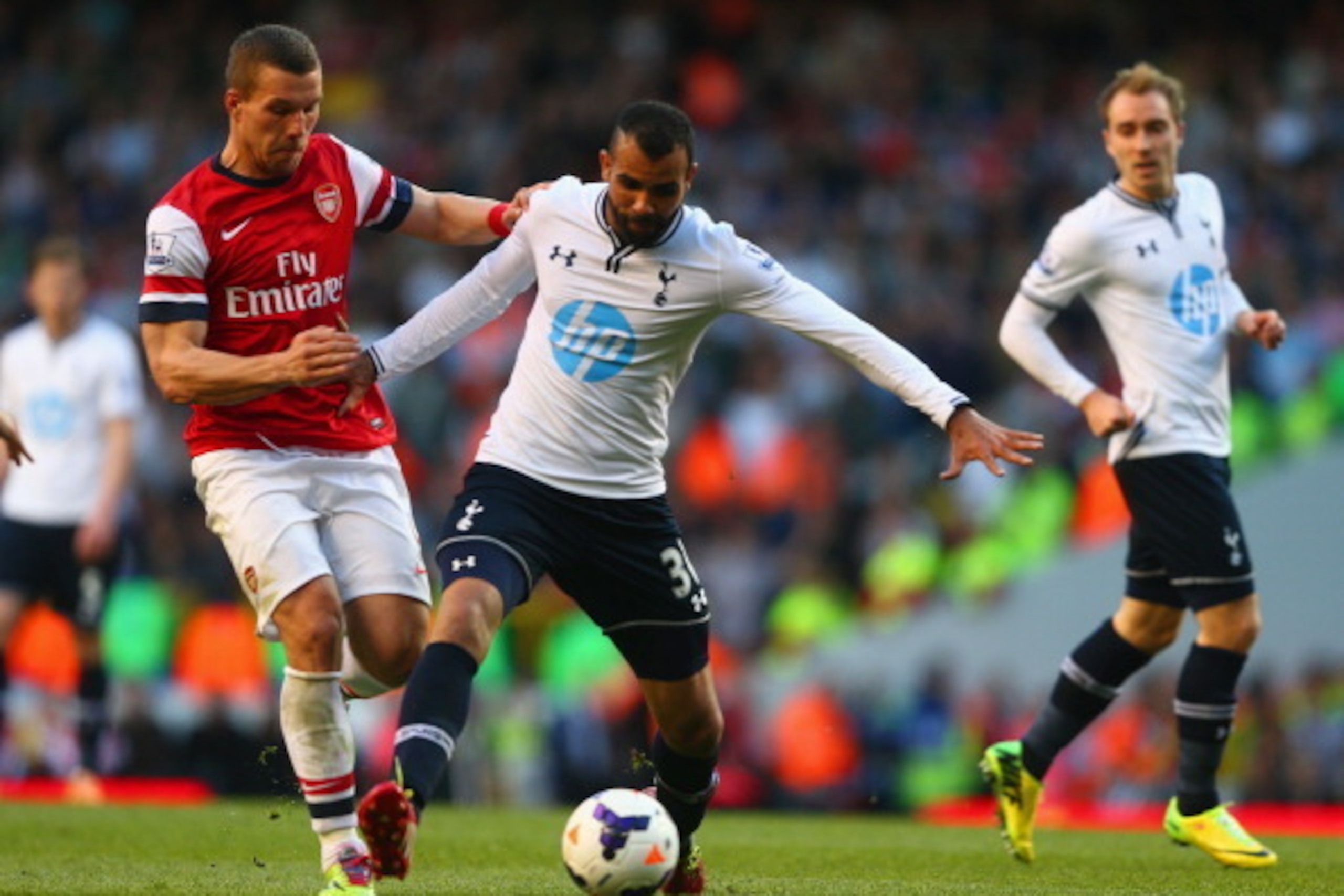LONDON, ENGLAND - MARCH 16:  Sandro of Tottenham Hotspur and Lukas Podolski of Arsenal competes for the ball during the Barclays Premier League match between Tottenham Hotspur and Arsenal at White Hart Lane on March 16, 2014 in London, England.  (Photo by