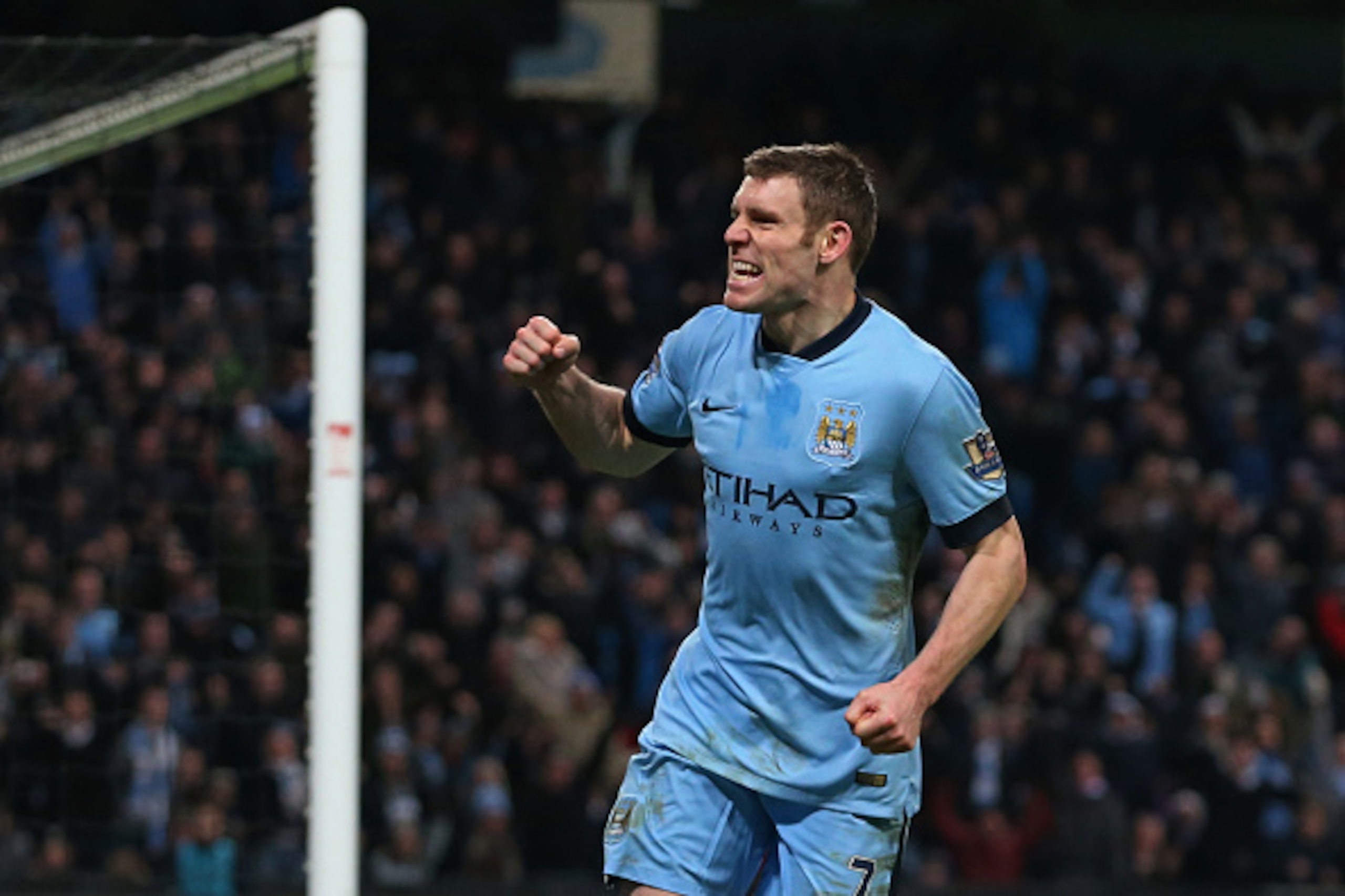 MANCHESTER, ENGLAND - JANUARY 04:  James Milner of Manchester City celebrates after scoring a goal to level the scores at 1-1 during the FA Cup Third Round match between  Manchester City and Sheffield Wednesday at Etihad Stadium on January 4, 2015 in Manc