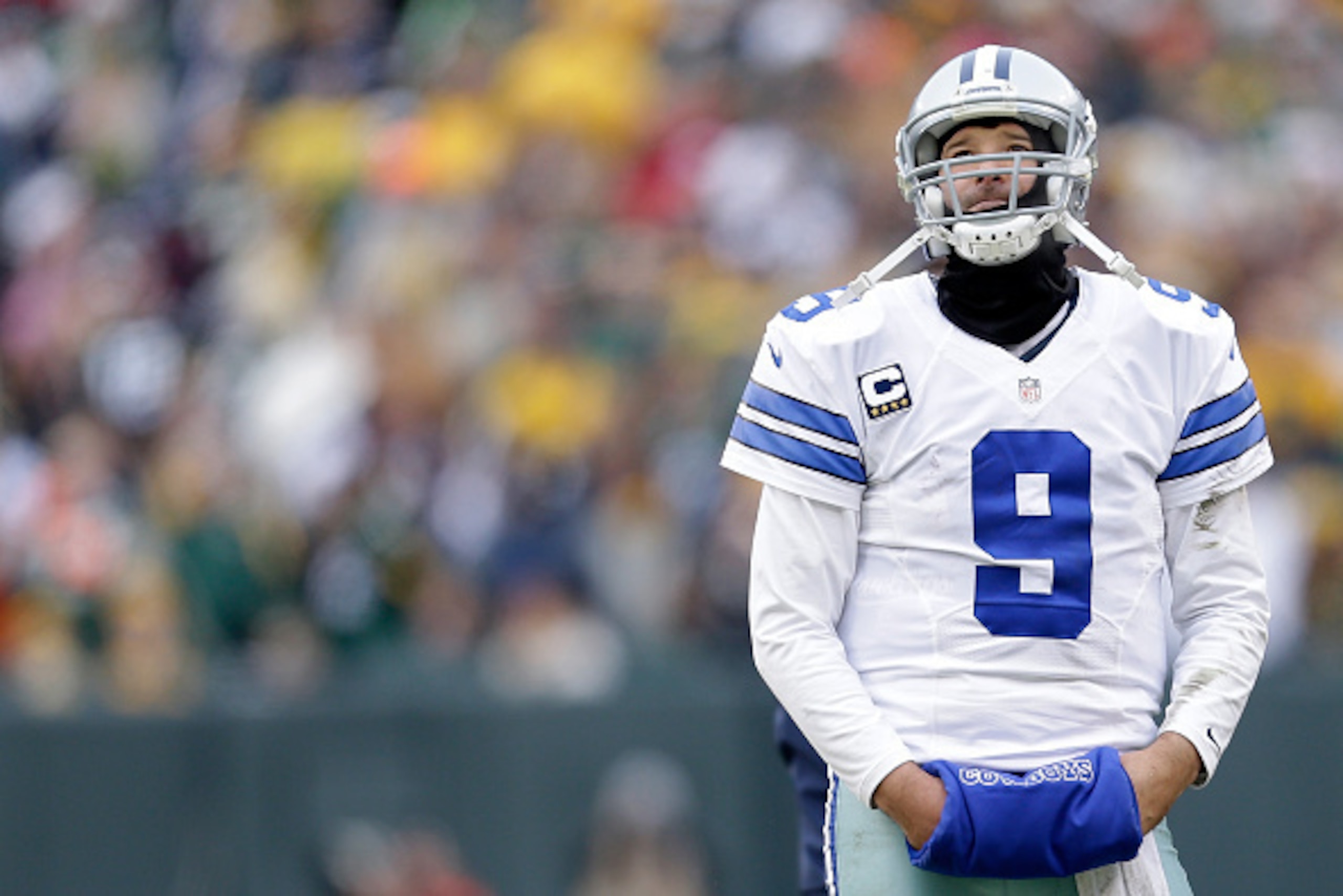 GREEN BAY, WI - JANUARY 11:  Quarterback  Tony Romo #9  of the Dallas Cowboys wait for the call on an instant replay during the 2015 NFC Divisional Playoff game against the Green Bay Packers at Lambeau Field on January 11, 2015 in Green Bay, Wisconsin.  (