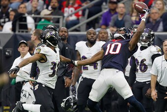 HOUSTON, TX - DECEMBER 21:  DeAndre Hopkins #10 of the Houston Texans has he ball go off his fingertips as he is defended by Rashaan Melvin #38 of the Baltimore Ravens at NRG Stadium on December 21, 2014 in Houston, Texas.  (Photo by Bob Levey/Getty Image