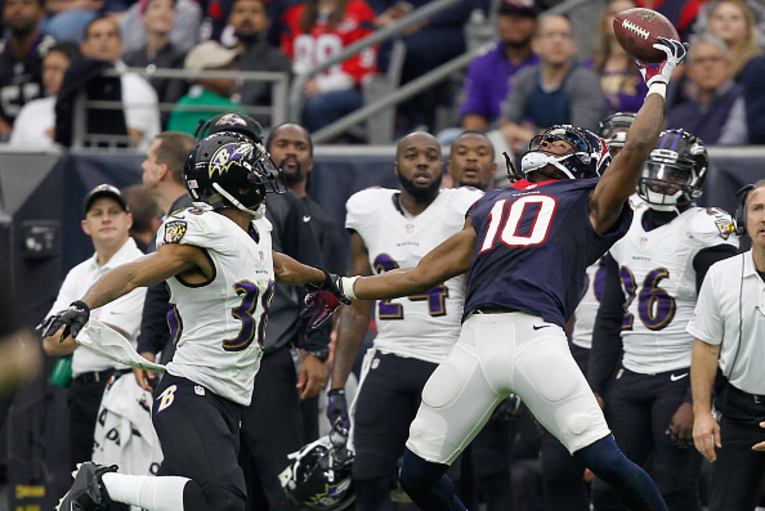 HOUSTON, TX - DECEMBER 21:  DeAndre Hopkins #10 of the Houston Texans has he ball go off his fingertips as he is defended by Rashaan Melvin #38 of the Baltimore Ravens at NRG Stadium on December 21, 2014 in Houston, Texas.  (Photo by Bob Levey/Getty Image