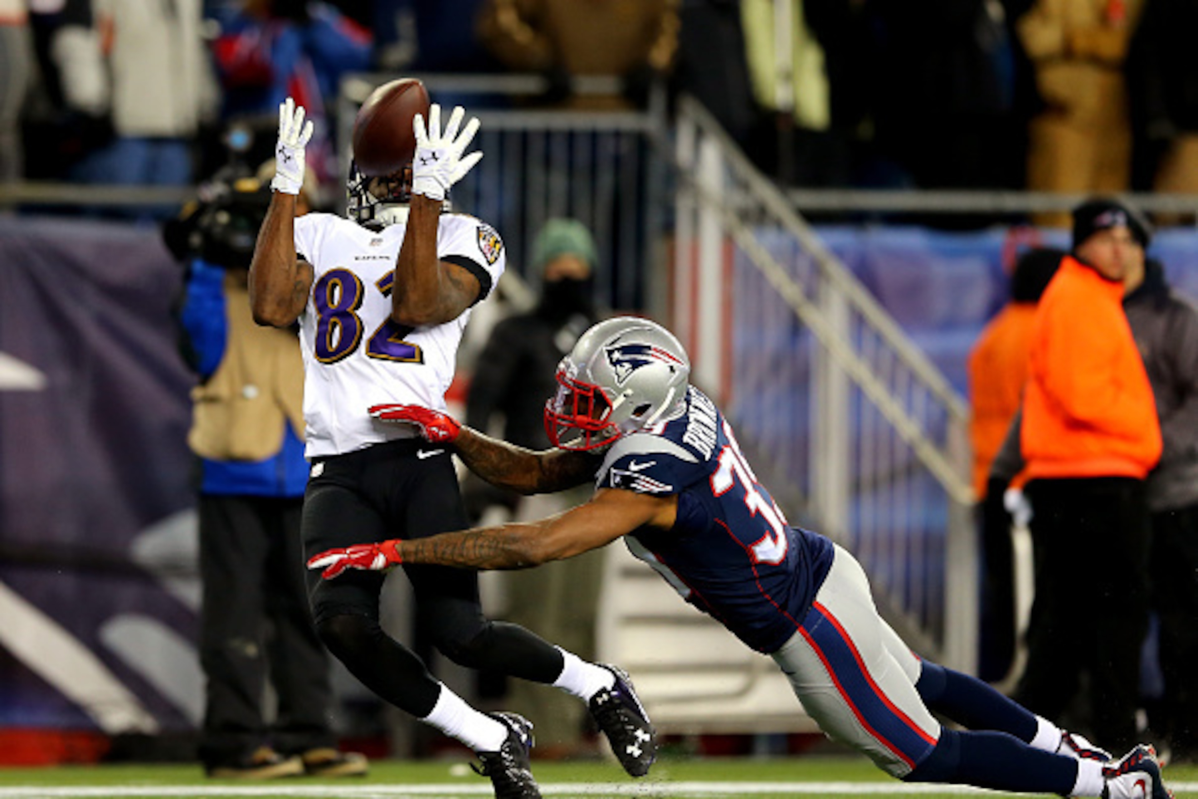 FOXBORO, MA - JANUARY 10:  Torrey Smith #82 of the Baltimore Ravens makes a catch against  LeGarrette Blount #29 of the New England Patriots in the third quarter during the 2015 AFC Divisional Playoffs game at Gillette Stadium on January 10, 2015 in Foxbo
