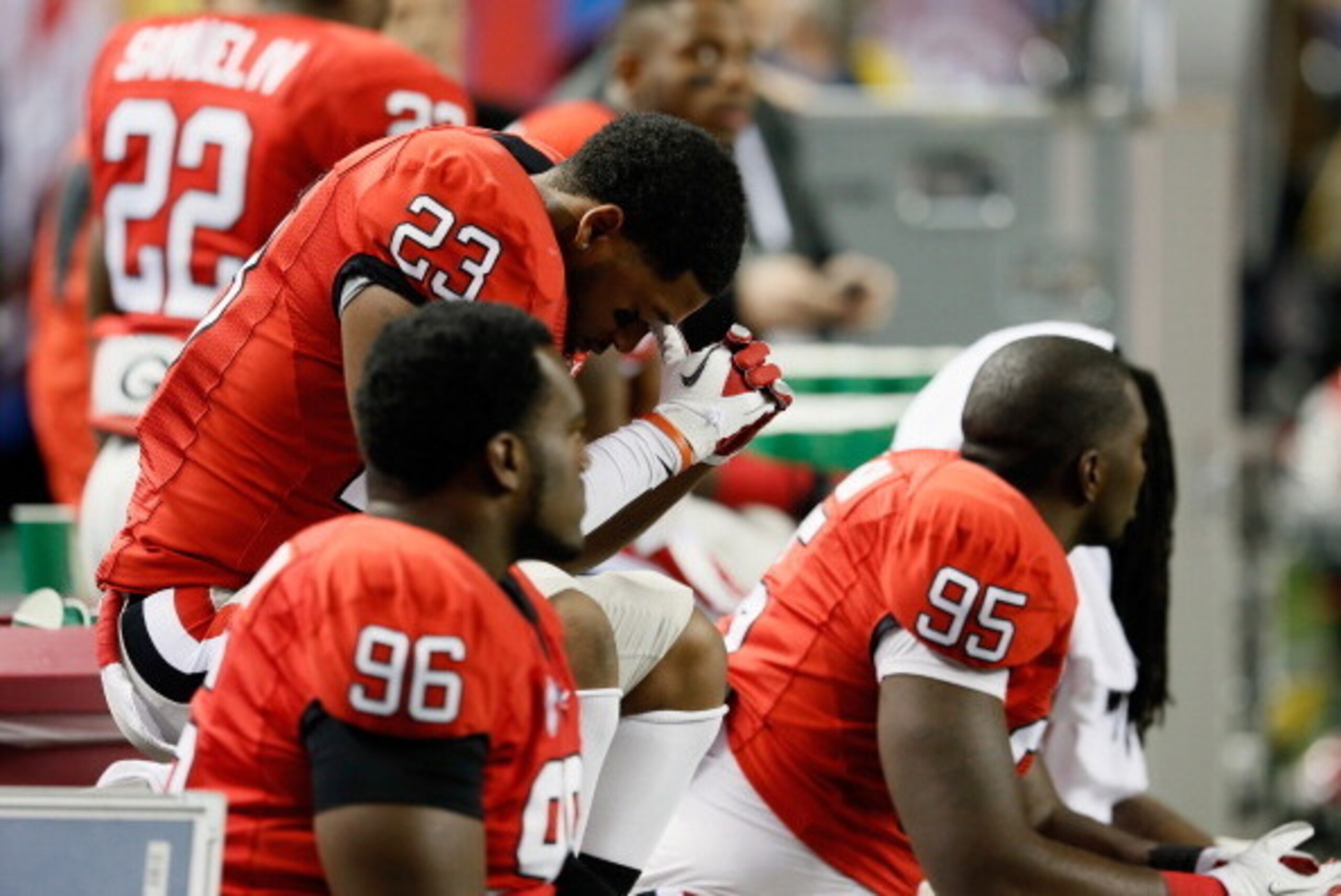 ATLANTA, GA - DECEMBER 01: Safety Marc Deas #23, linebacker Reuben Faloughi #95, and 
defensive lineman Mike Thornton #96 of the Georgia Bulldogs sit on the bench during the closing moments of the Bulldogs 32-28 loss to the Alabama Crimson Tide during the