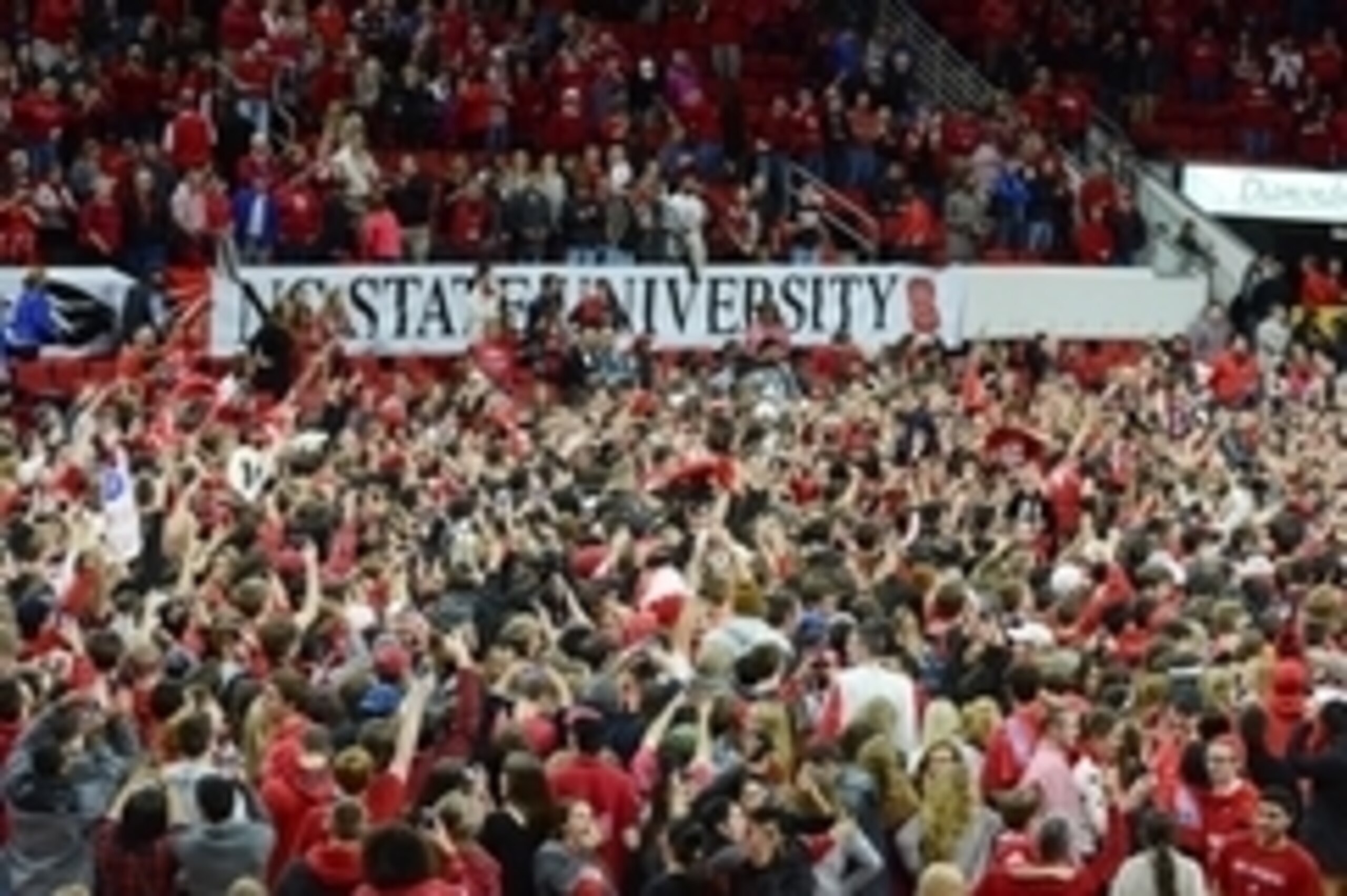 Jan 11, 2015; Raleigh, NC, USA; North Carolina State Wolfpack fans storm the court after a victory against the Duke Blue Devils during the second half at PNC Arena. North Carolina State won 87-75.  Mandatory Credit: Rob Kinnan-USA TODAY Sports
