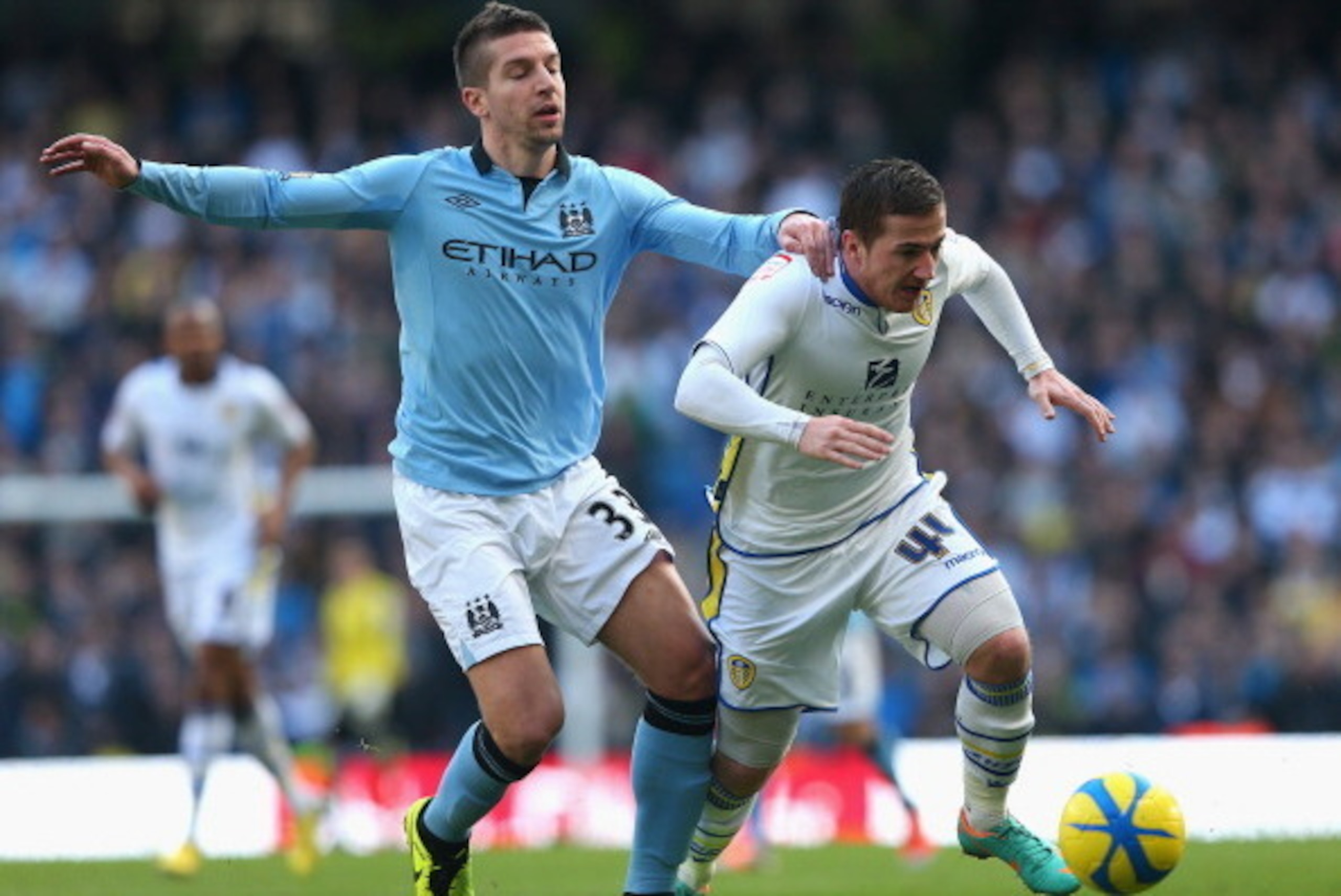 MANCHESTER, ENGLAND - FEBRUARY 17:  Matija Nastasic of Manchester City competes with Ross McCormack of Leeds United during the FA Cup with Budweiser Fifth Round match between Manchester City and Leeds United at the Etihad Stadium on February 17, 2013 in M