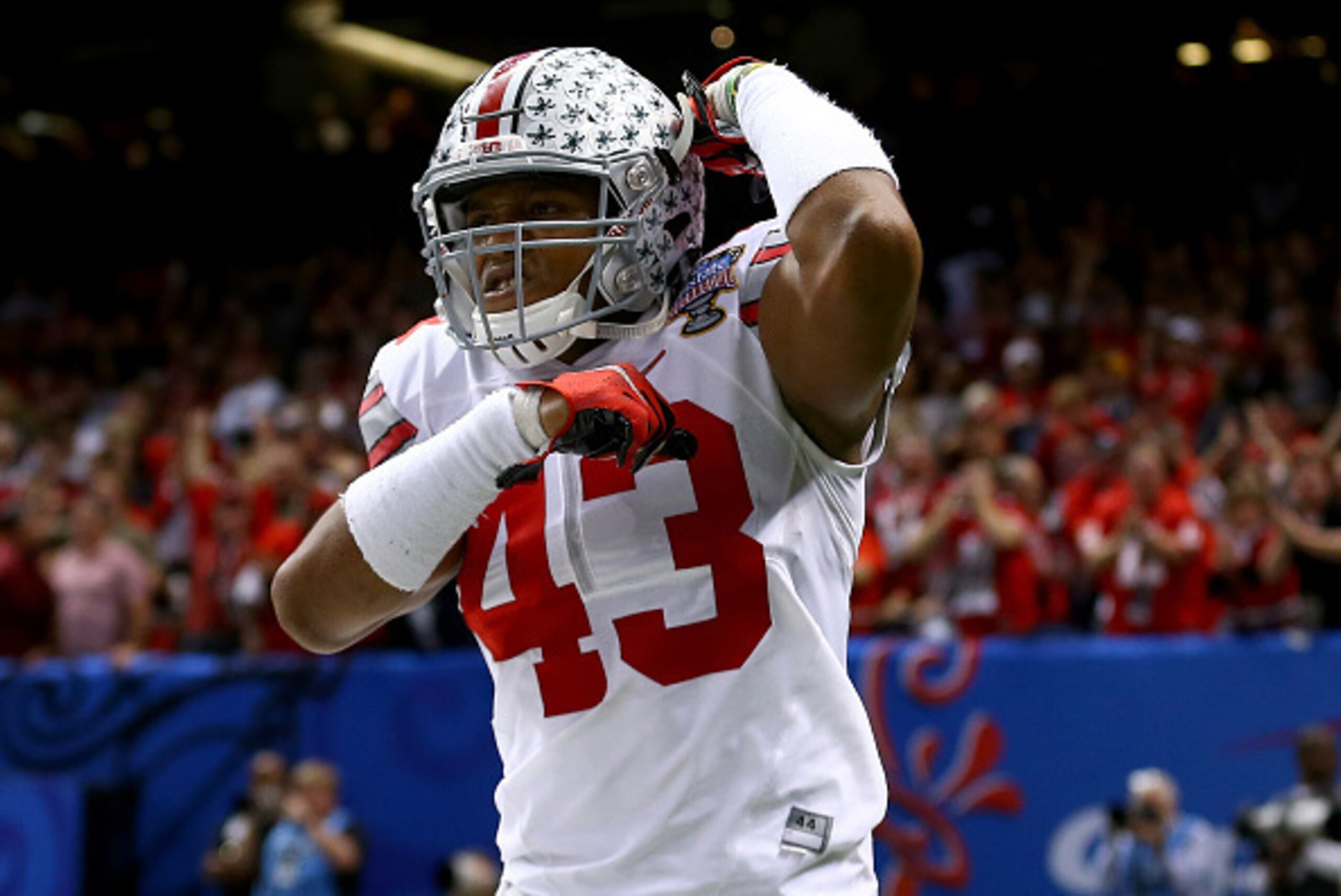 NEW ORLEANS, LA - JANUARY 01:  Darron Lee #43 celebrates teammate Steve Miller #88 of the Ohio State Buckeyes after scoring a 41 yard interception return from Blake Sims #6 of the Alabama Crimson Tide in the third quarter during the All State Sugar Bowl a
