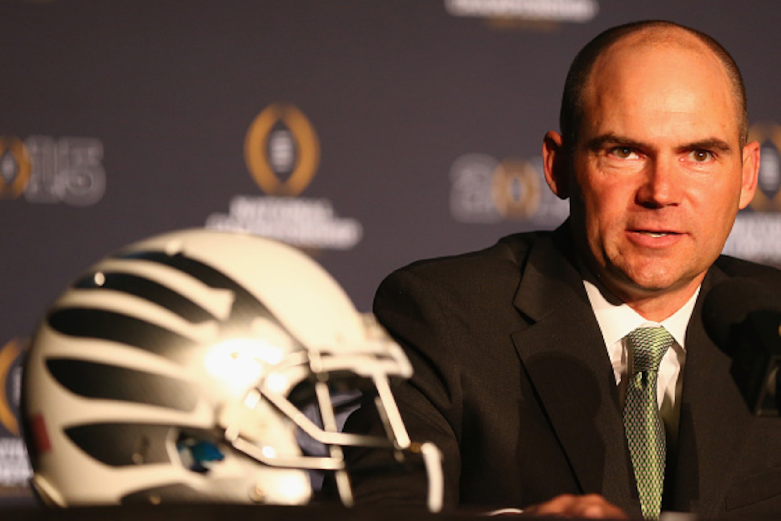 DALLAS, TX - JANUARY 11:  Head Coach Mark Helfrich of the Oregon Ducks speaks with the media in front of the College Football Playoff National Championship trophy during a Head Coaches press conference at the Renaissance Dallas Hotel on January 11, 2015 i