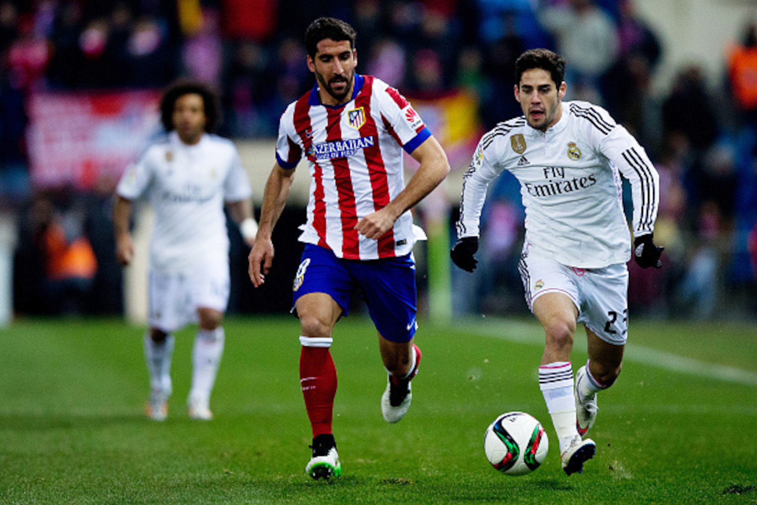 MADRID, SPAIN - JANUARY 07: Francisco Roman Alarcon alias Isco (R) of Real Madrid CF competes for the ball with Raul Garcia (L) of Atletico de Madrid during the Copa del Rey Round of 16  first leg match between Club Atletico de Madrid and Real Madrid CF a