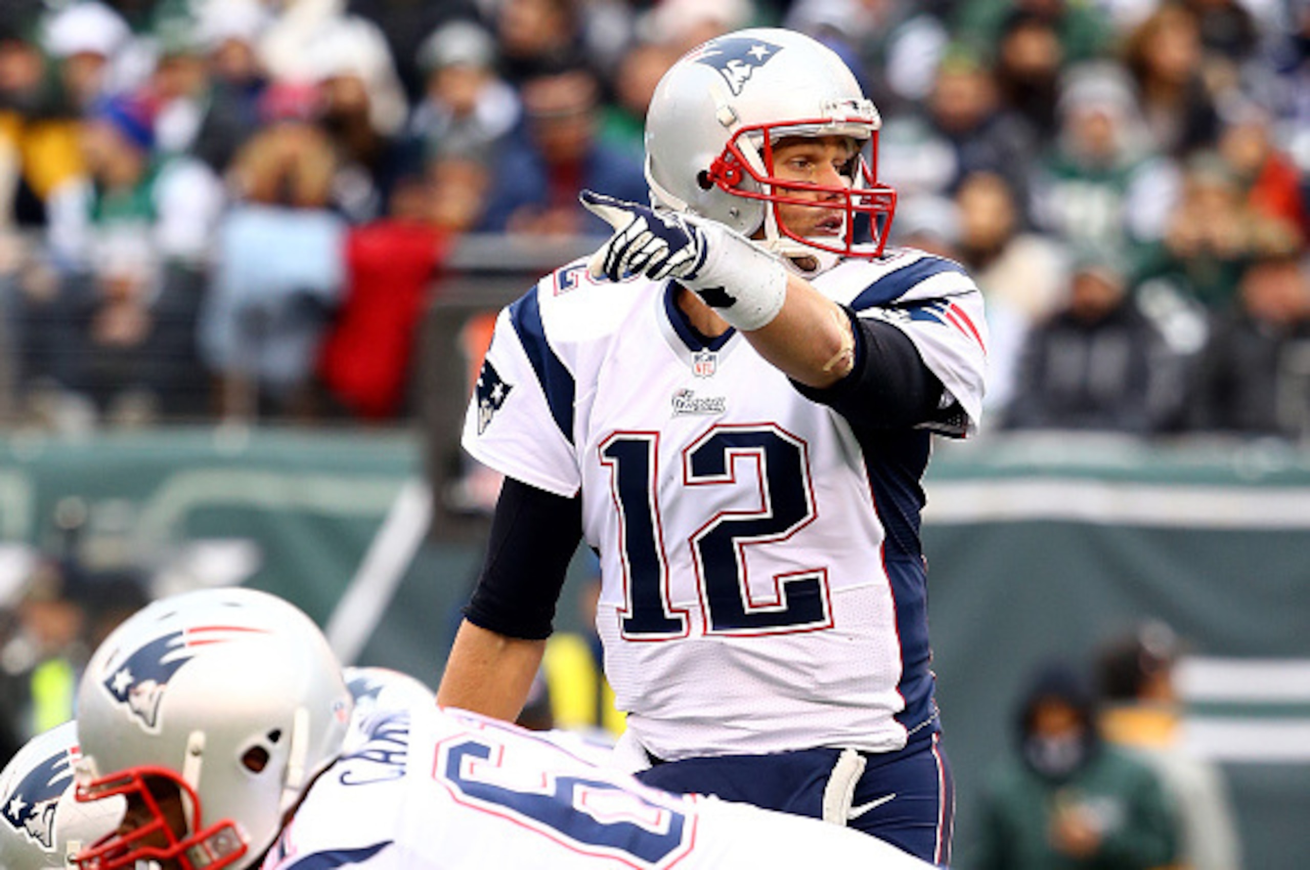 EAST RUTHERFORD, NJ - DECEMBER 21:  Quarterback Tom Brady #12 of the New England Patriots calls a play against the New York Jets during a game at MetLife Stadium on December 21, 2014 in East Rutherford, New Jersey.  (Photo by Al Bello/Getty Images)