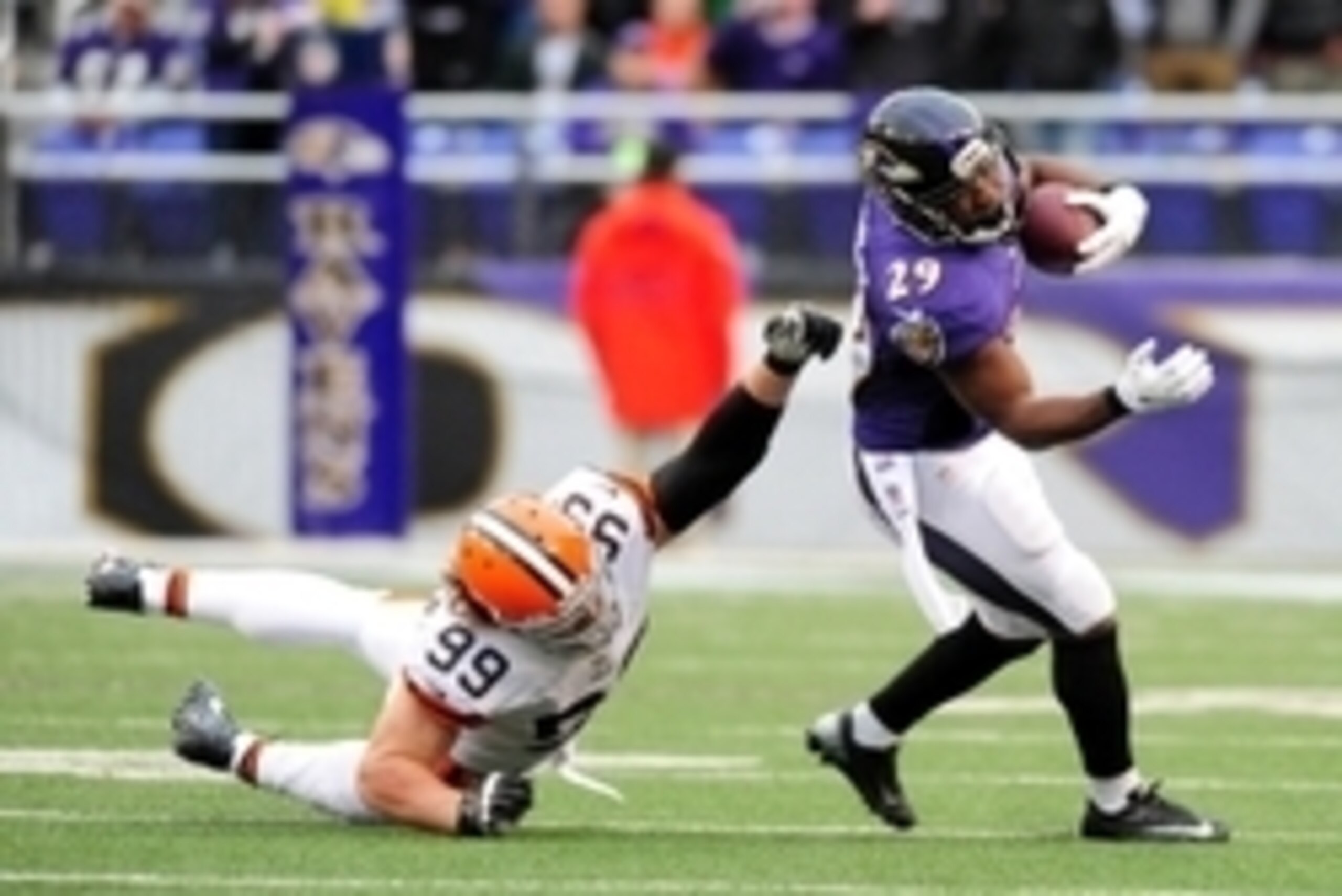 Dec 28, 2014; Baltimore, MD, USA; Baltimore Ravens running back Justin Forsett (29) breaks the tackle of Cleveland Browns linebacker Paul Kruger (99) at M&T Bank Stadium. Mandatory Credit: Evan Habeeb-USA TODAY Sports