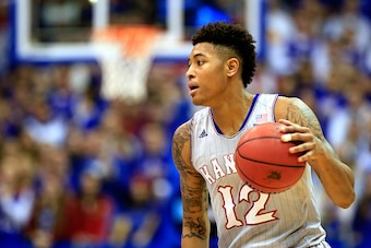 LAWRENCE, KS - DECEMBER 30:  Kelly Oubre Jr. #12 of the Kansas Jayhawks controls the ball during the game against the Kent State Golden Flashes at Allen Fieldhouse on December 30, 2014 in Lawrence, Kansas.  (Photo by Jamie Squire/Getty Images)