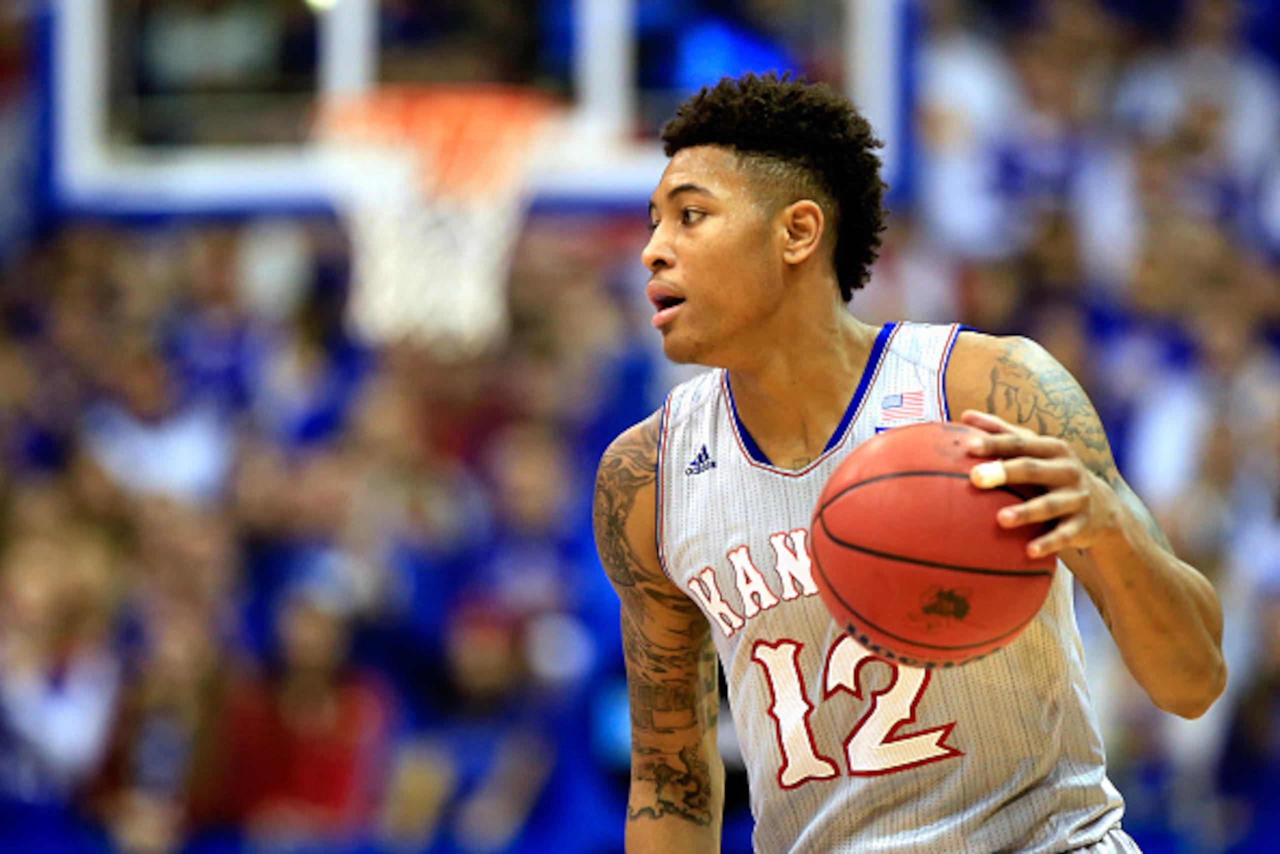 LAWRENCE, KS - DECEMBER 30:  Kelly Oubre Jr. #12 of the Kansas Jayhawks controls the ball during the game against the Kent State Golden Flashes at Allen Fieldhouse on December 30, 2014 in Lawrence, Kansas.  (Photo by Jamie Squire/Getty Images)