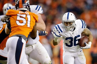 DENVER, CO - JANUARY 11:  Dan Herron #36 of the Indianapolis Colts rushes against the Denver Broncos  during a 2015 AFC Divisional Playoff game at Sports Authority Field at Mile High on January 11, 2015 in Denver, Colorado.  (Photo by Ezra Shaw/Getty Imag