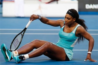 Serena Williams tries to recover from a fall during a 2015 Hopman Cup match.