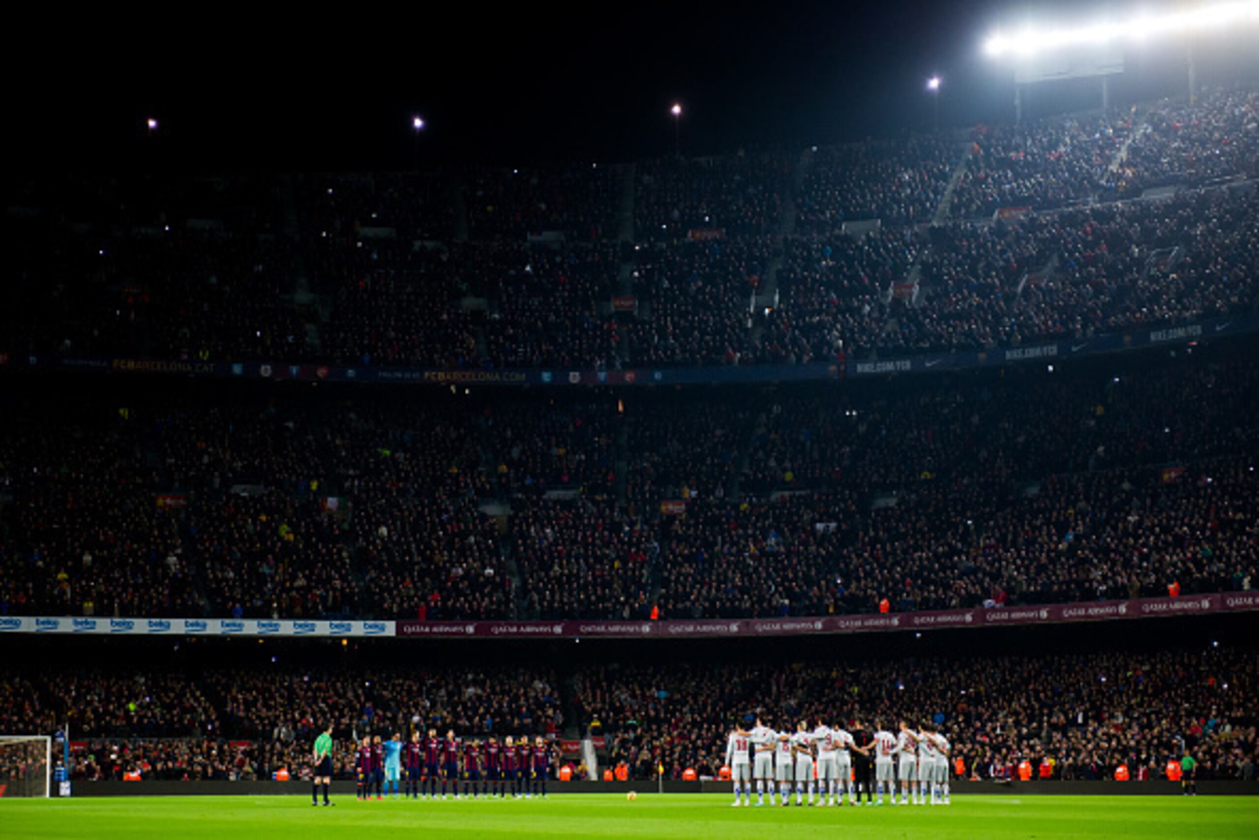 BARCELONA, SPAIN - JANUARY 11: Players of FC Barcelona and Club Atletico de Madrid observe a minute of silence in memory of the victims of terrorist attacks in Paris, France before the La Liga match between FC Barcelona and Club Atletico de Madrid at Camp