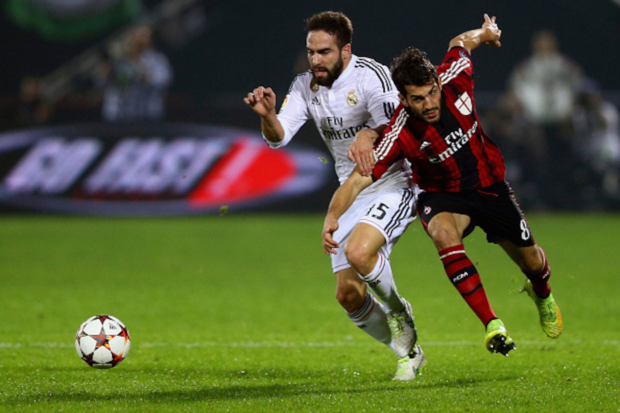 DUBAI, UNITED ARAB EMIRATES - DECEMBER 30:  Dani Carvajal of Real Madrid battles for the ball with Ricardo Saponara of AC Milan during the Dubai Football Challenge match between AC Milan and Real Madrid at The Sevens Stadium  on December 30, 2014 in Dubai