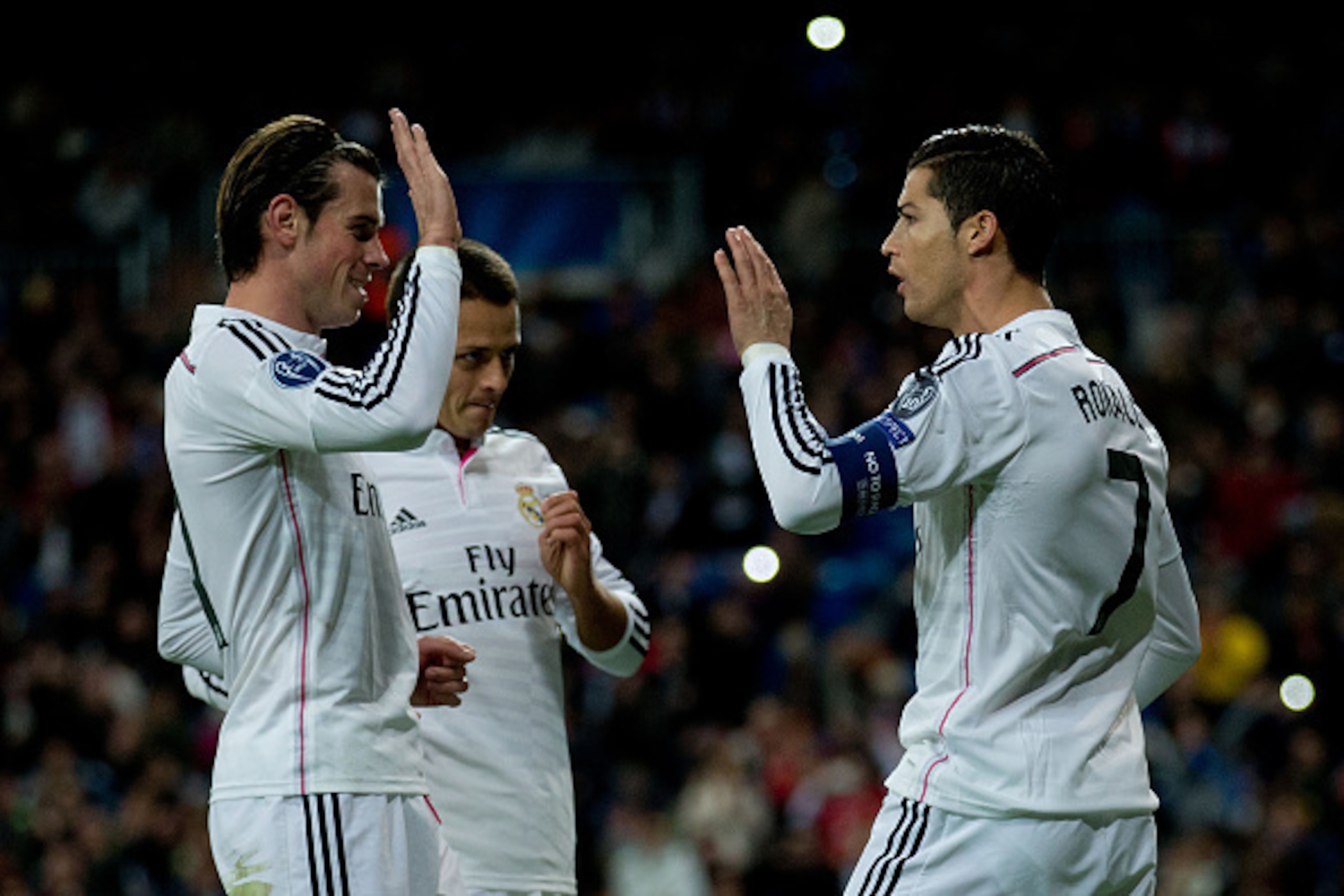 MADRID, SPAIN - DECEMBER 09:  Cristiano Ronaldo (R) of Real Madrid CF celebrates scoring their opening goal with teammates Gareth Bale (L) and Javier Hernandez Chicharito (2ndL) during the UEFA Champions League Group B match between Real Madrid CF and PFC