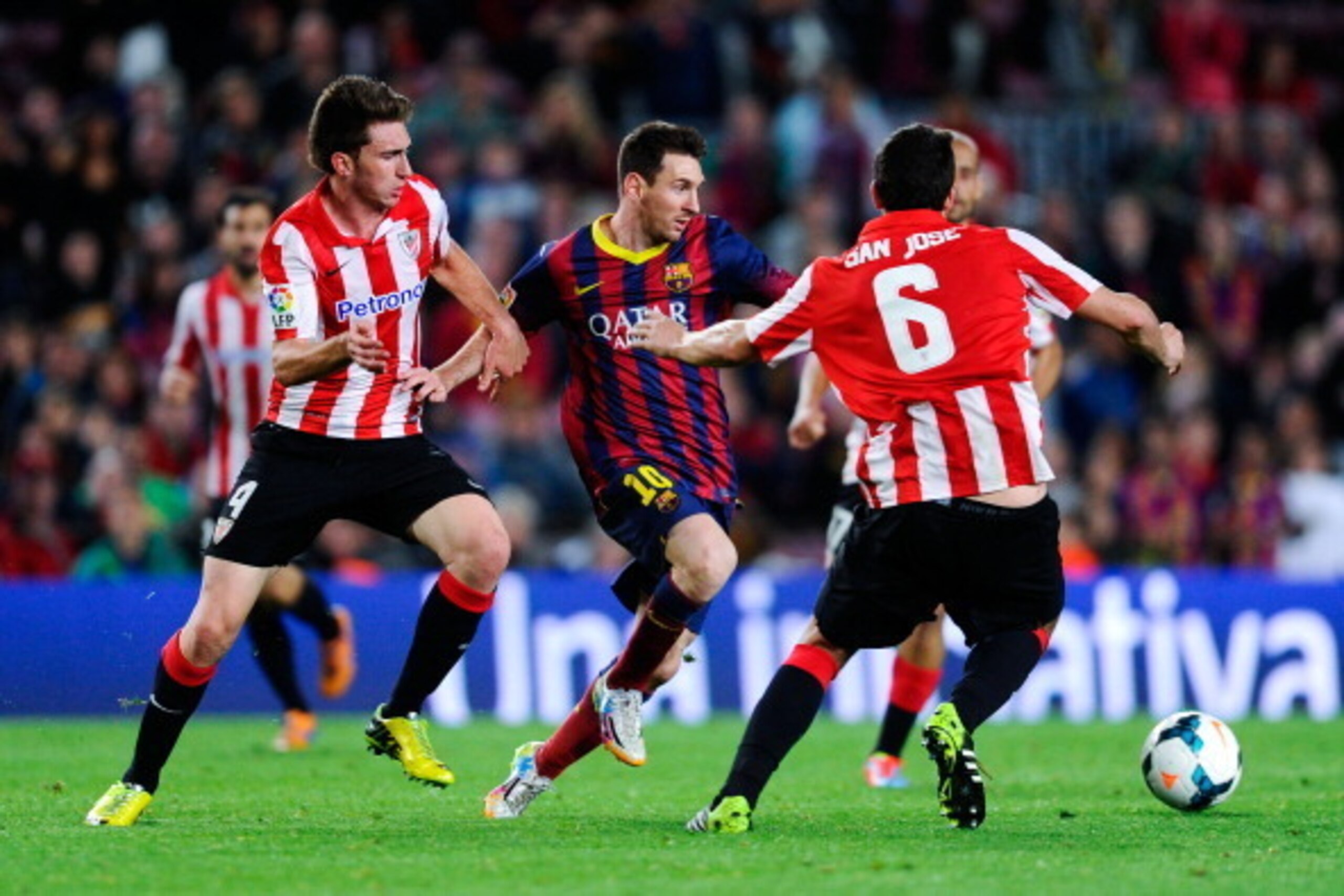 BARCELONA, SPAIN - APRIL 20:  Lionel Messi of FC Barcelona competes for the ball with Aymeric Laporte (L) and Mikel San Jose of Athletic Club during the La Liga match between FC Barcelona and Athletic Club at Camp Nou on April 20, 2014 in Barcelona, Spain